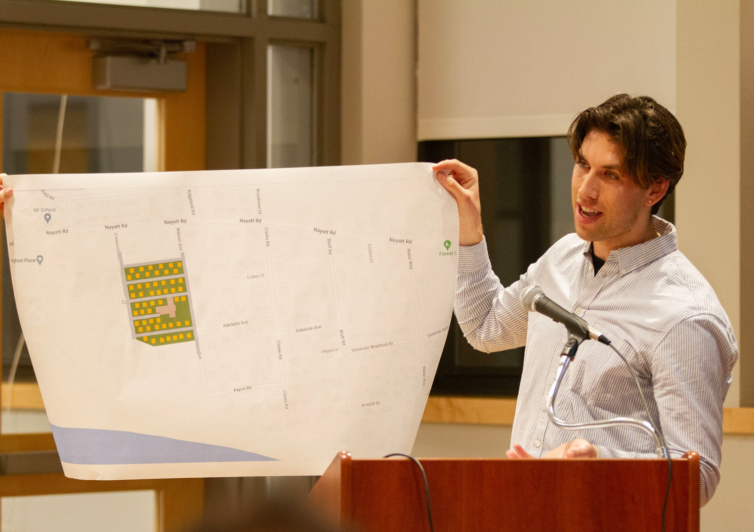 Blaise Rein holds up an image, detailing the potential density of a development.
