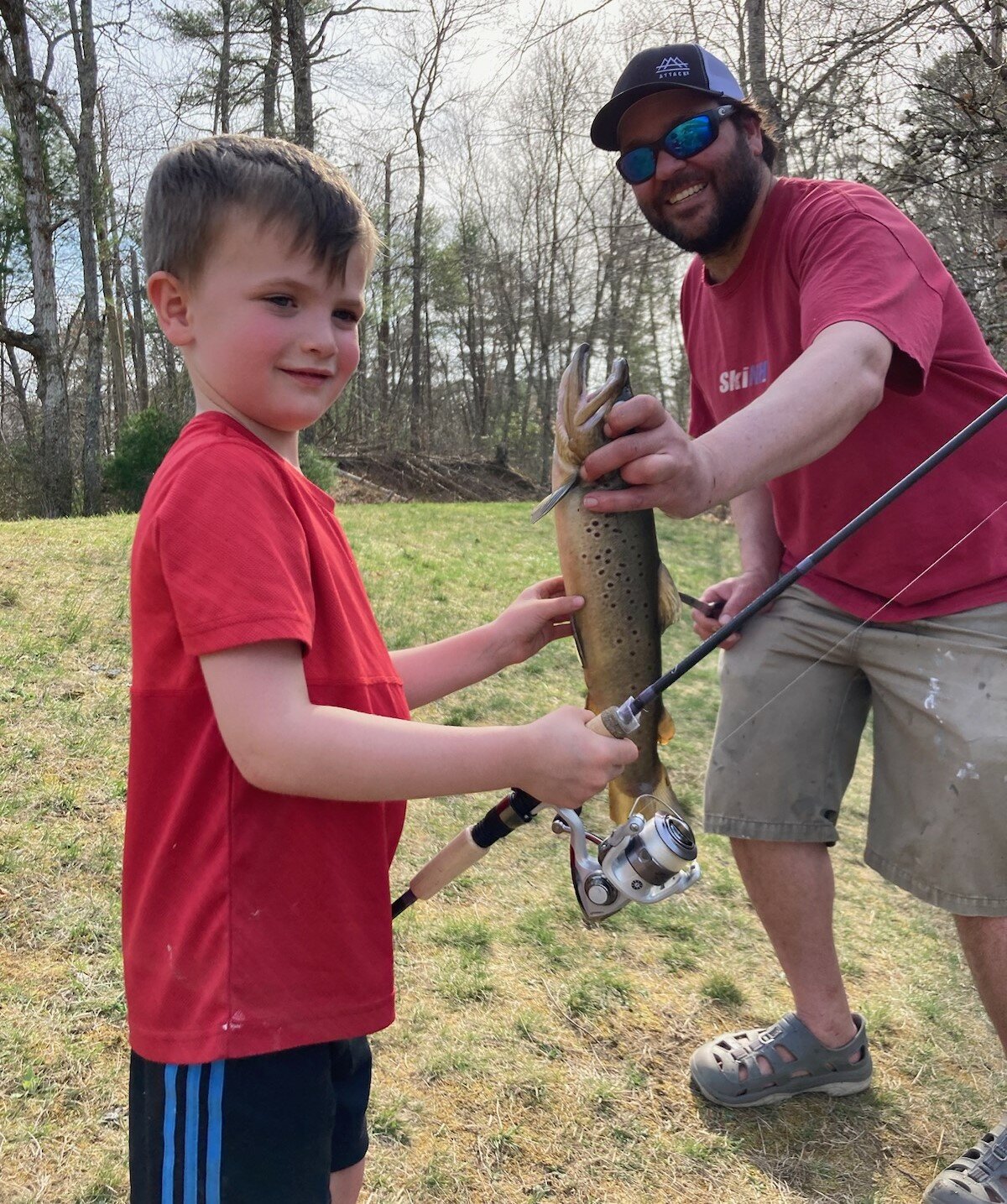 Henry Matoni (5 years old) of Charlestown and Matt Conti with the brown trout Henry caught at the Carolina Trout Pond, Richmond.