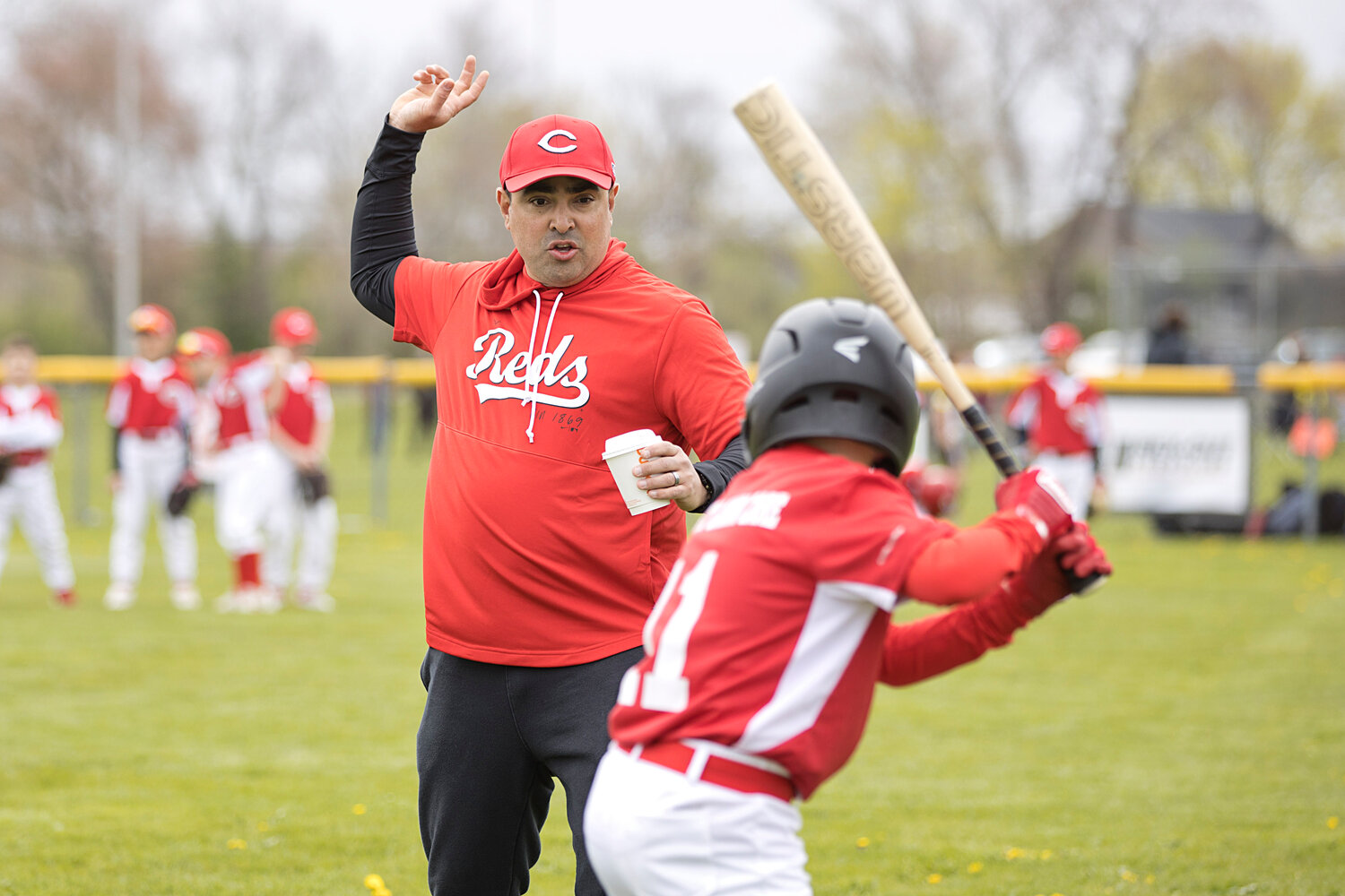 Dan Medeiros warms his team up before their first game Saturday. 