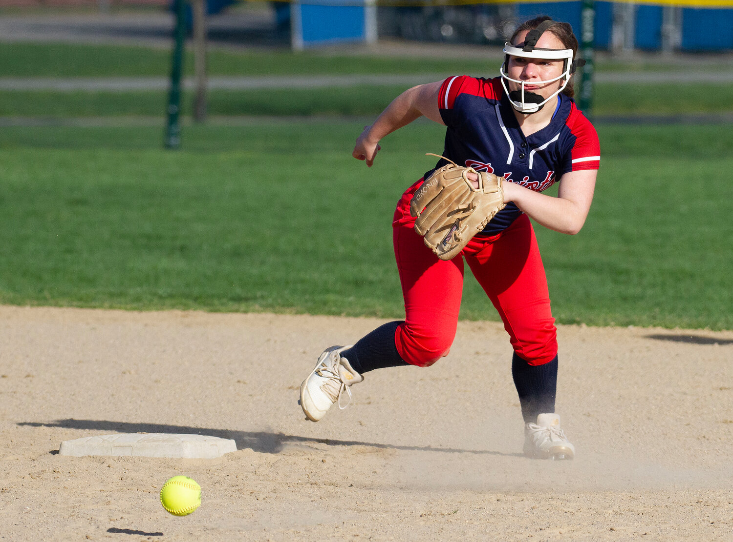 Second baseman Maggie Lauder rushes a slow-rolling grounder.