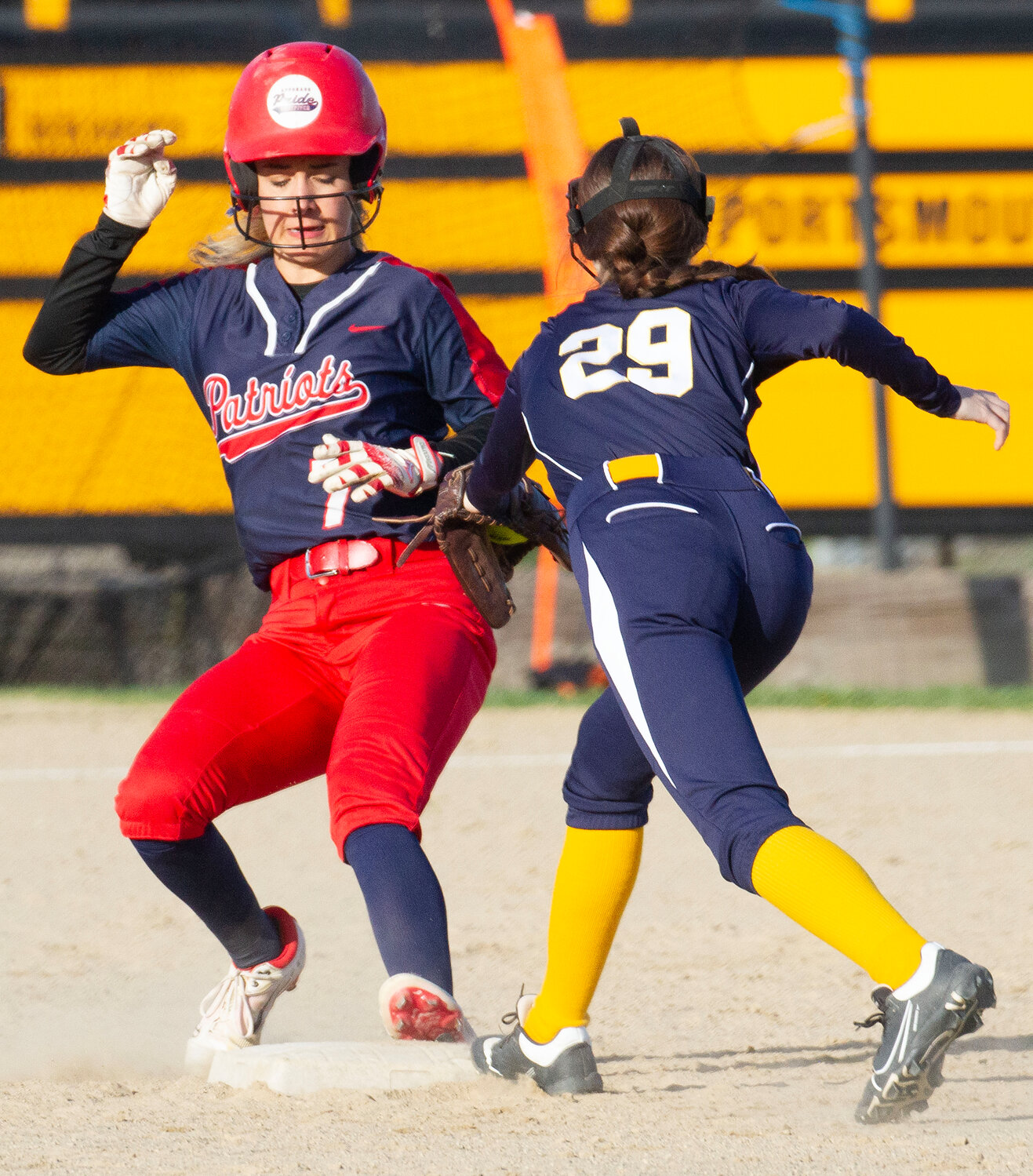 Sophomore Mary Rainey scampers back to second base safely as she overran the bag during the Patriots’ win over Barrington on Thursday.