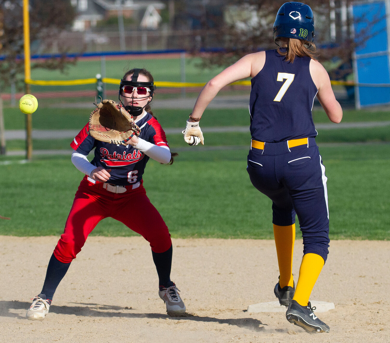Portsmouth High shortstop Megan Malone takes a throw from first baseman Kaelyn Mahoney on a grounder to first to force out a Barrington baserunner last Thursday, April 20.