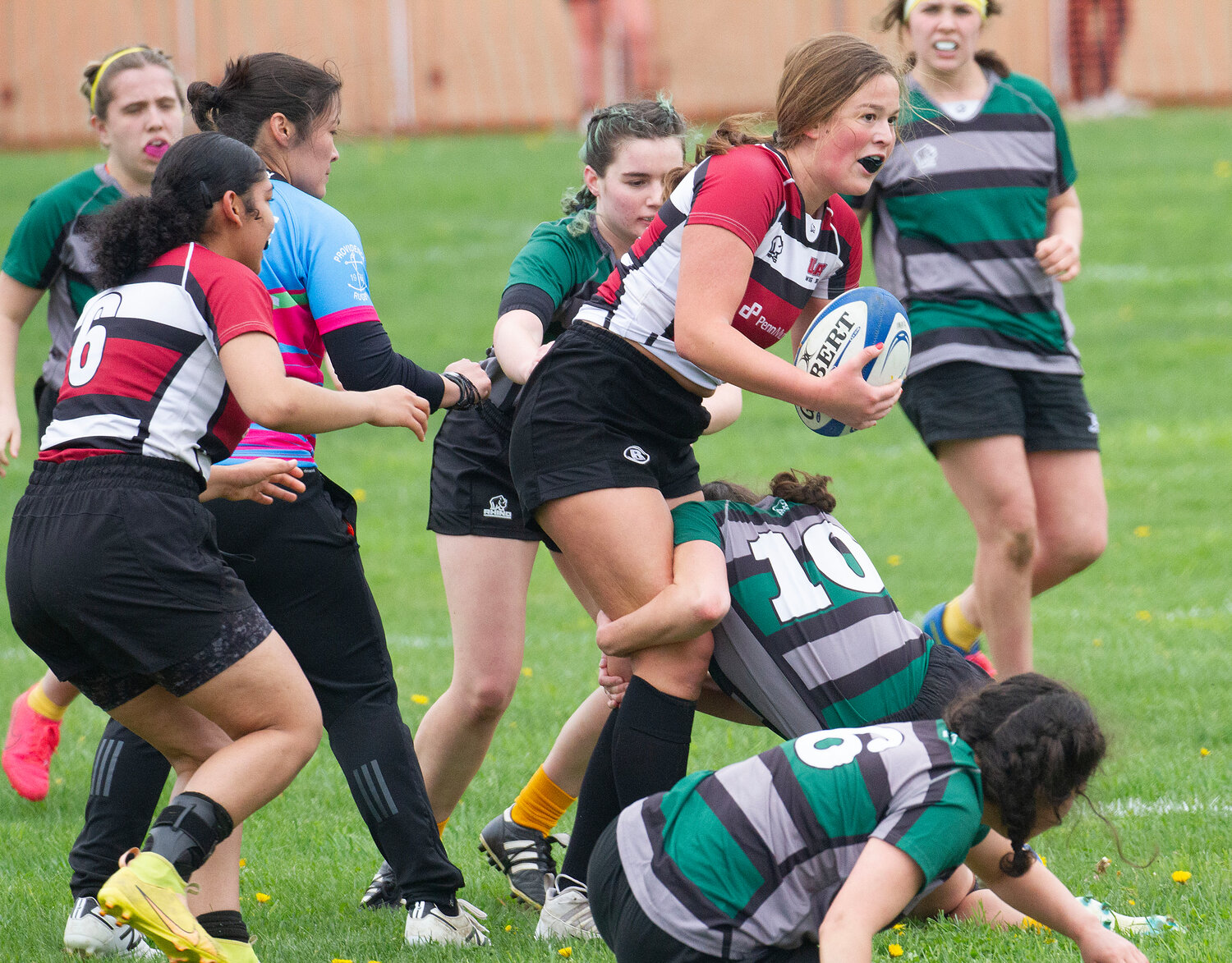 UMass fly half Micheala Pomroy gets tackled by UVM defenders.