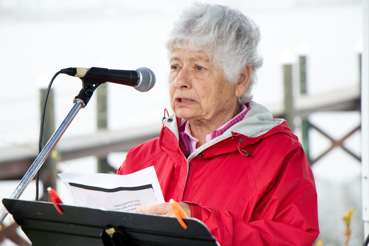Judy Carvalho reads a poem, “On Those Days” by Donna Ashworth, during the vigil.