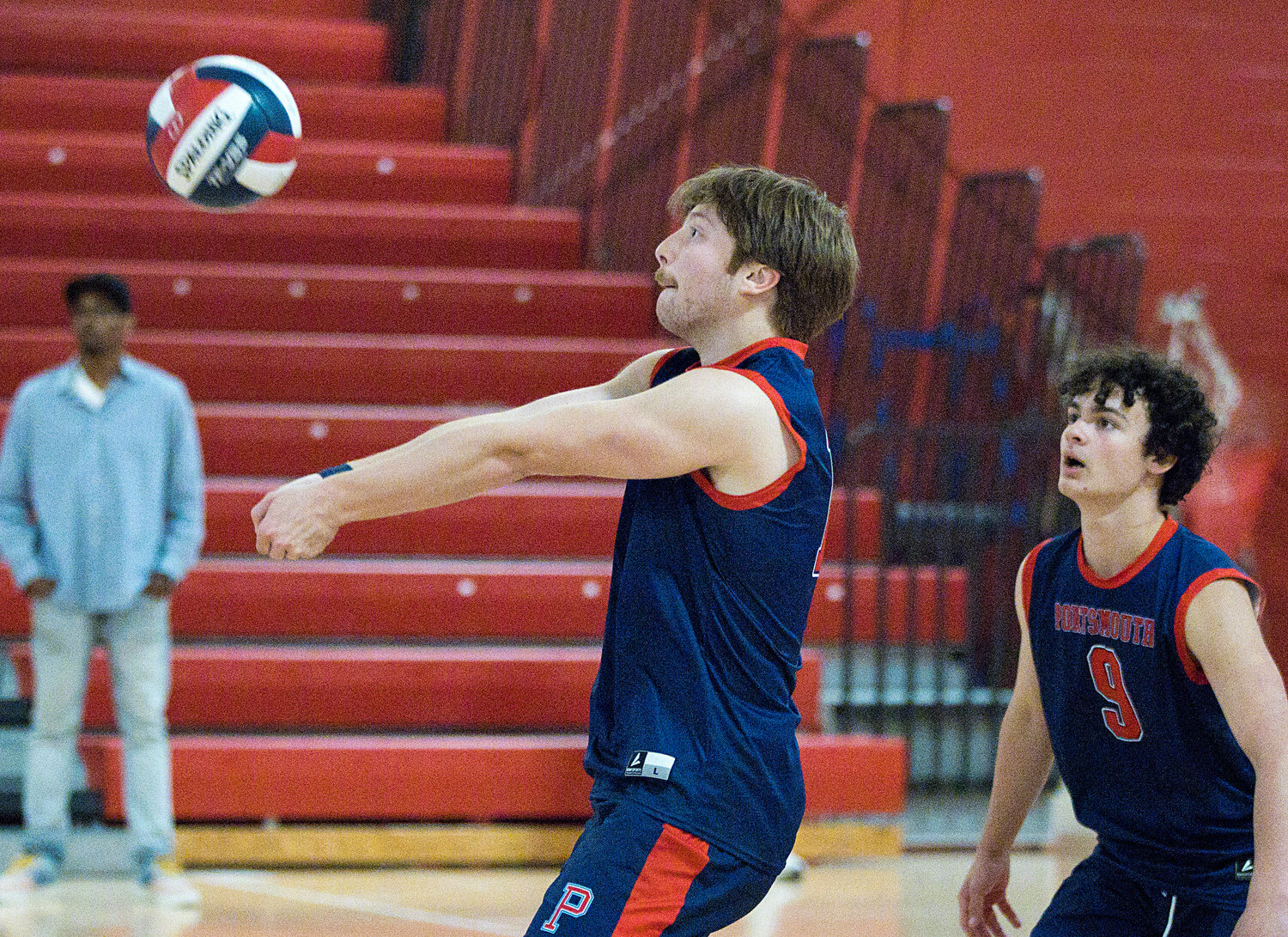 Adam Banks (right) looks on as Nick Waycuilis passes the ball to a teammate.