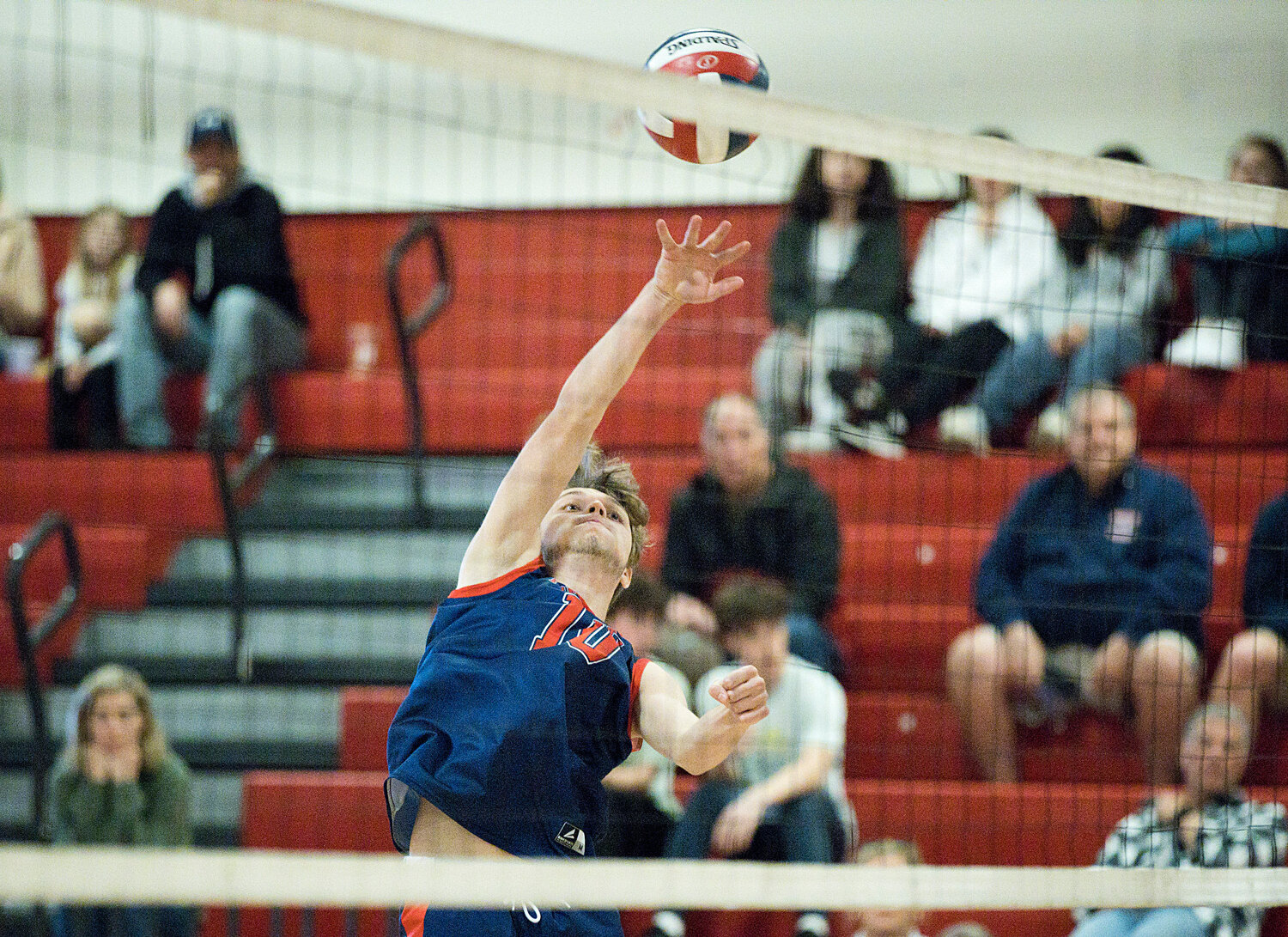 Hayden Krzych fires the ball over the net while rallying with St. Ray’s.