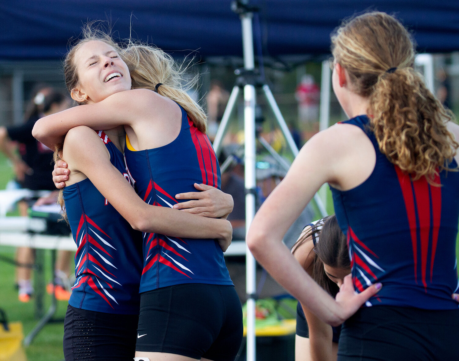 Katie Yalanis hugs teammate Hanalei Streuli after the 800-meter run. Streuli came in fifth, and Yalanis in 10th.