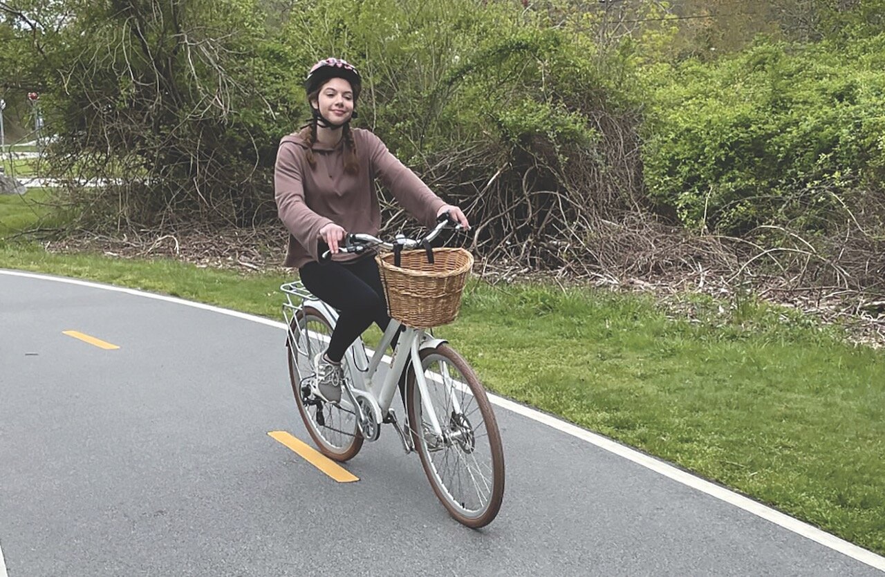 Author Julia Stearly pedals a Class 1 electric bicycle on the East Bay Bike Path while traveling south from Colt State Park.