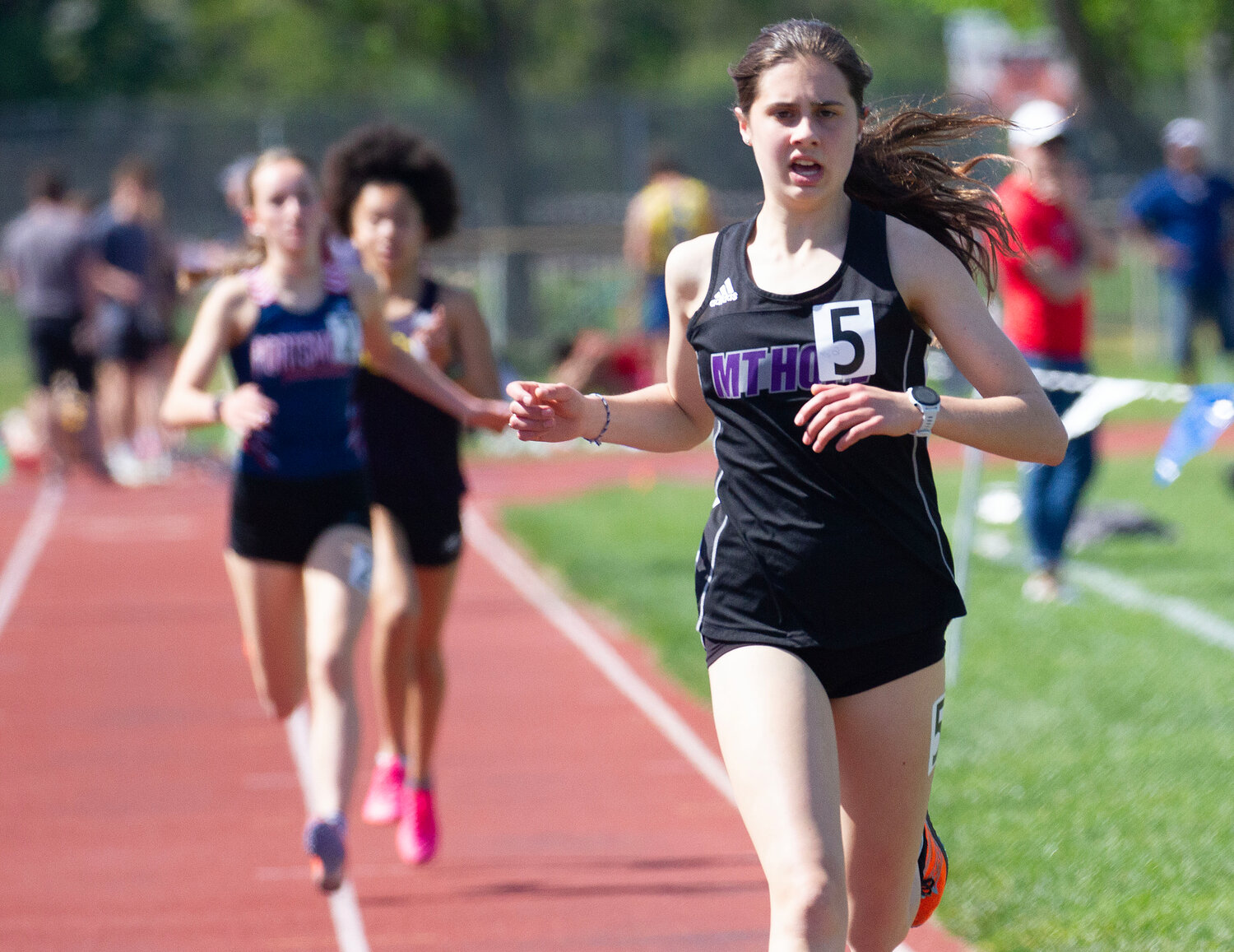 Freshman Jessica Deal heads for the finish line during the 1500 meter run, in front of Portsmouth’s Allie Kaull and St. Rays’ Chandaniey Boyce. She won the race with a time of 5:01.56. Deal also won the 3000 meter run.