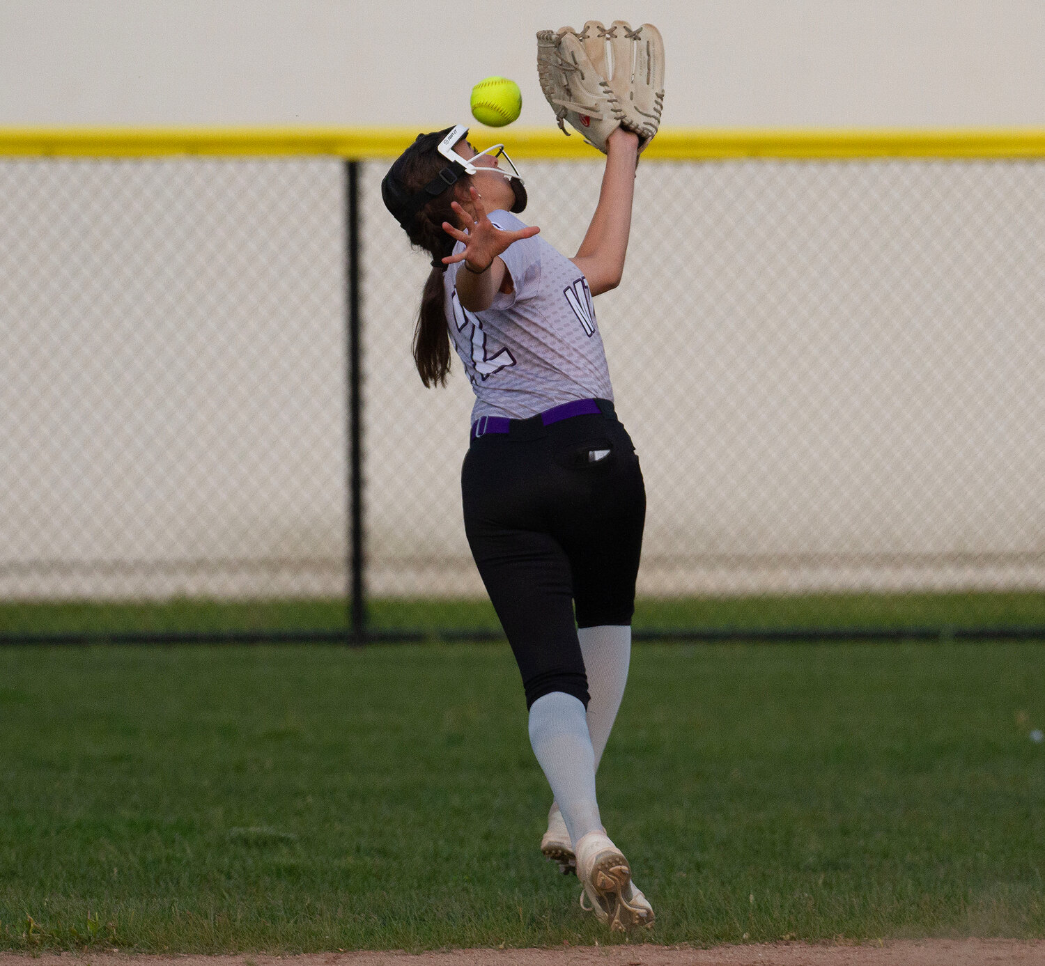 Elsa White attempts to catch a ball hit to the right centerfield gap.