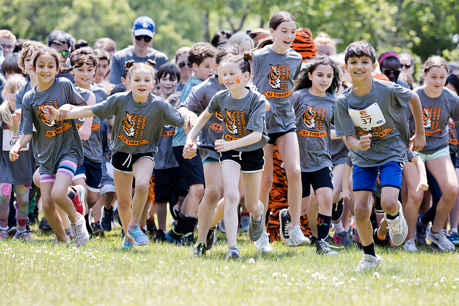 The first wave of runners take off at the start of Hampden Meadow's "Tough Tiger" race, Sunday.