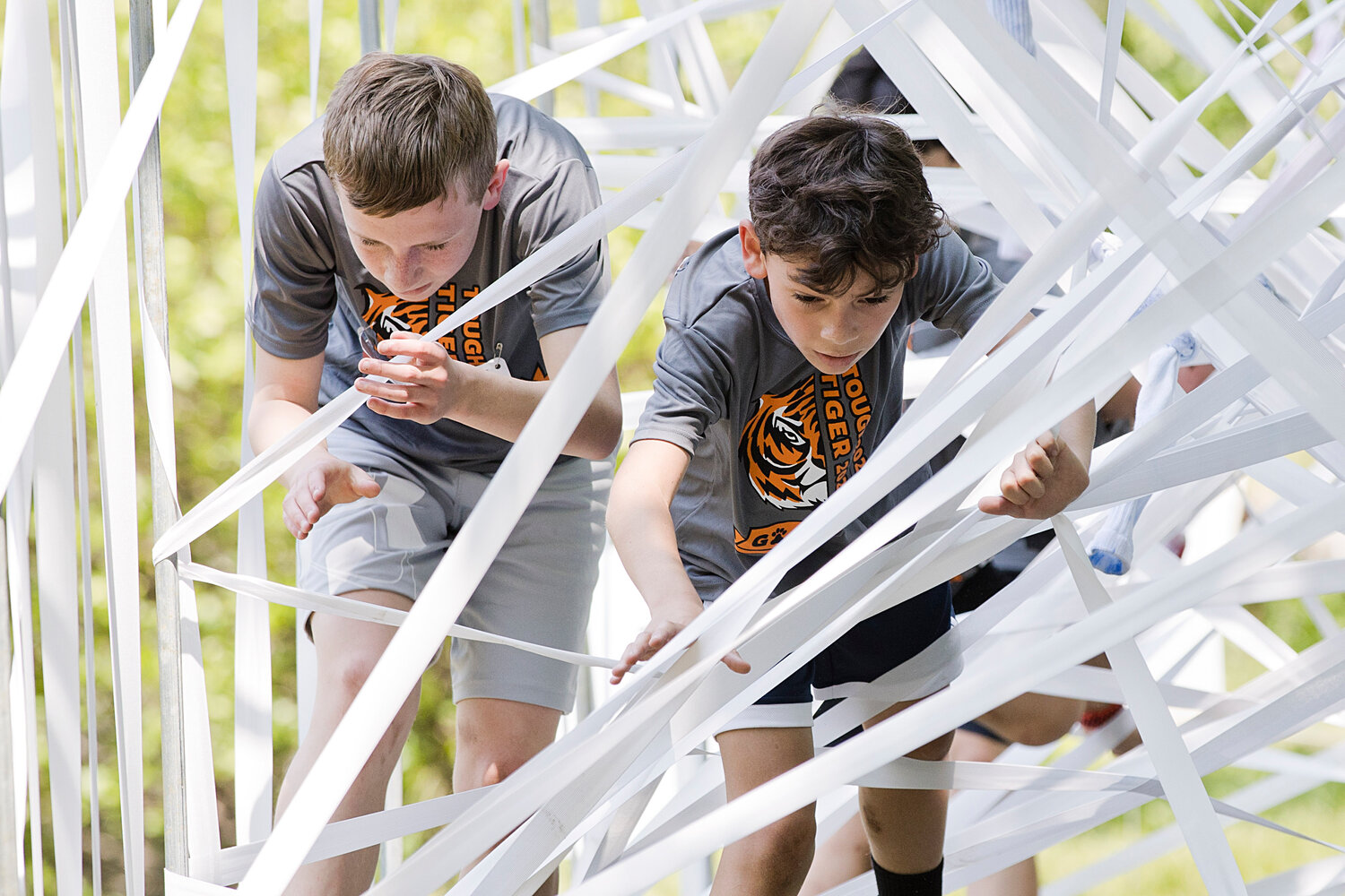 "Tough Tiger" participants make their way through a webbed maze.