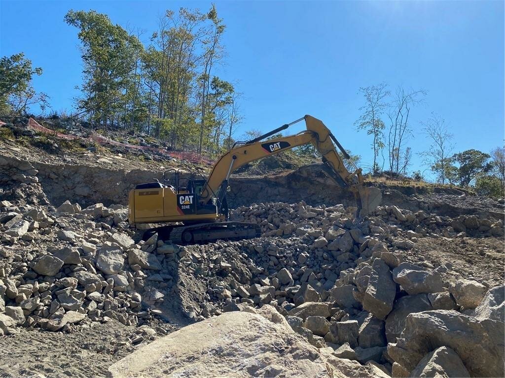 A photo taken from the property's MLS listing shows heavy equipment at the Highland Road quarry.