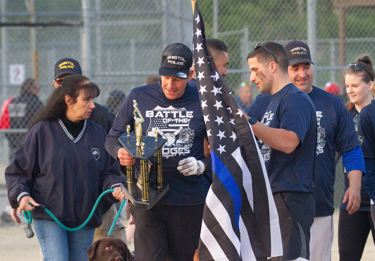 Chief Kevin Lynch is award the new trophy after the Police won 11-10 in extra innings to win the first annual B battle of the Badges softball game.