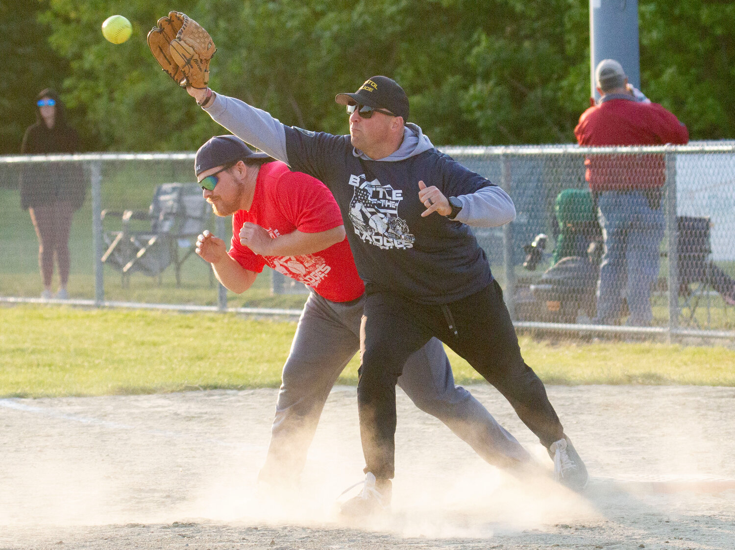 First baseman Brian Morse makes the catch as the police try to double up firefighter, Wilson Luther at first base.