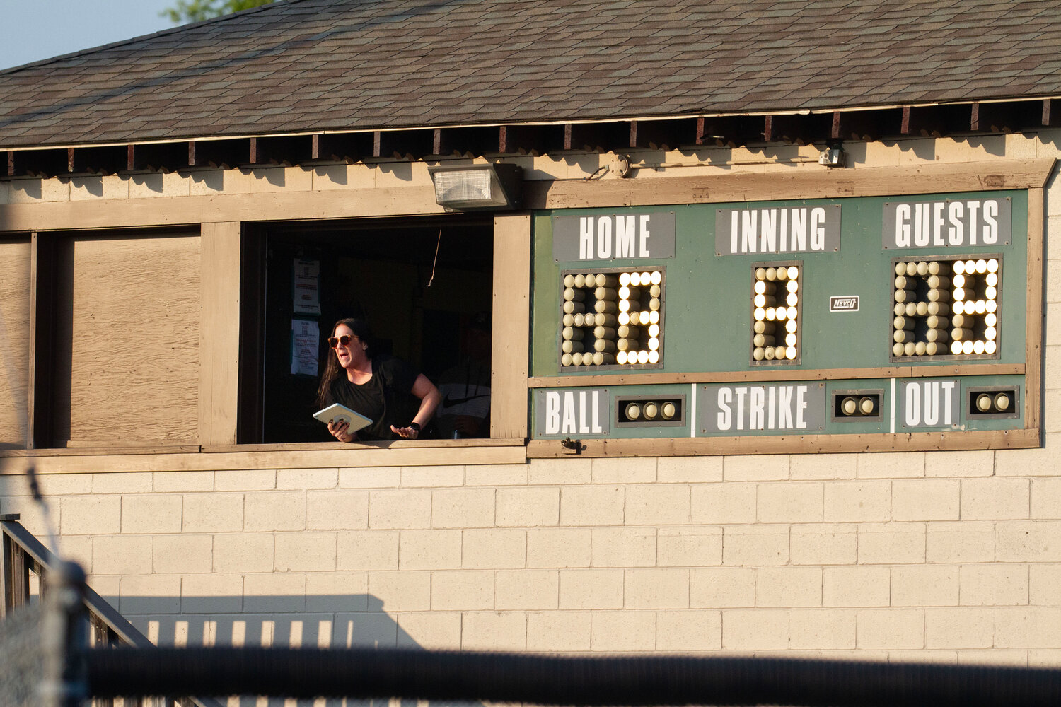 Scorekeeper Katie Urban questions the ump during the game.