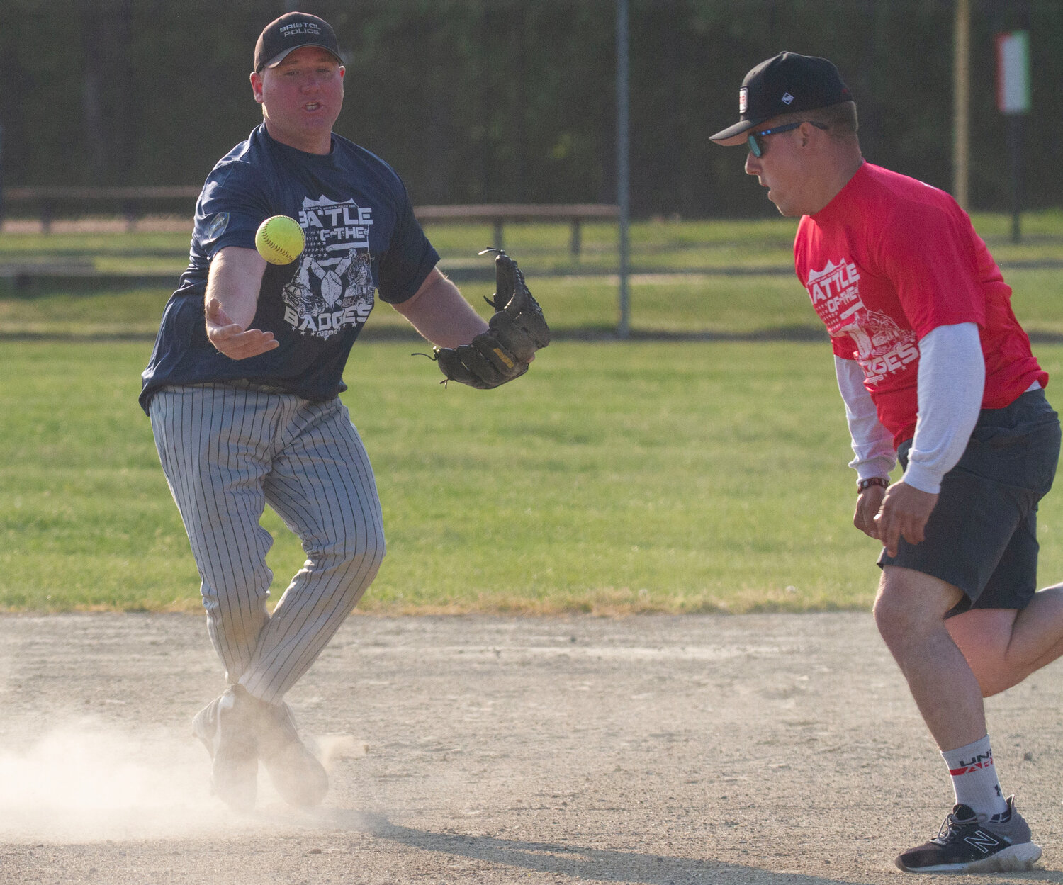 Second baseman Mike Kelly bobbles the ball and tags out a firefighter.