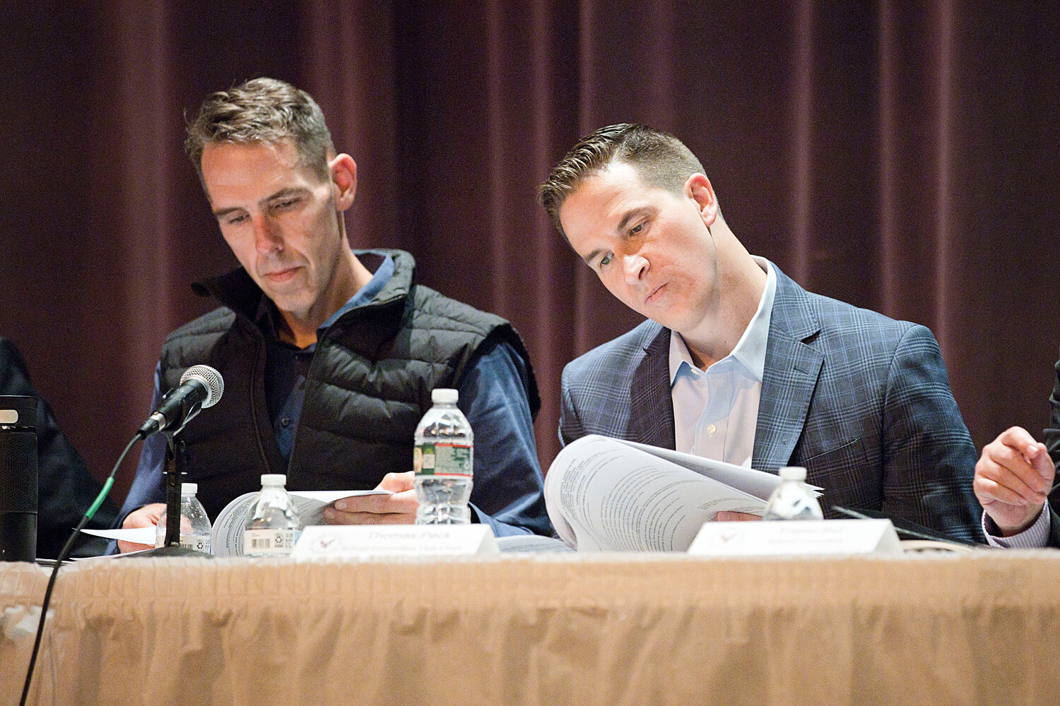 Barrington School Committee members Patrick McCrann (left) and TJ Peck read through the paperwork at Wednesday night's FTM.