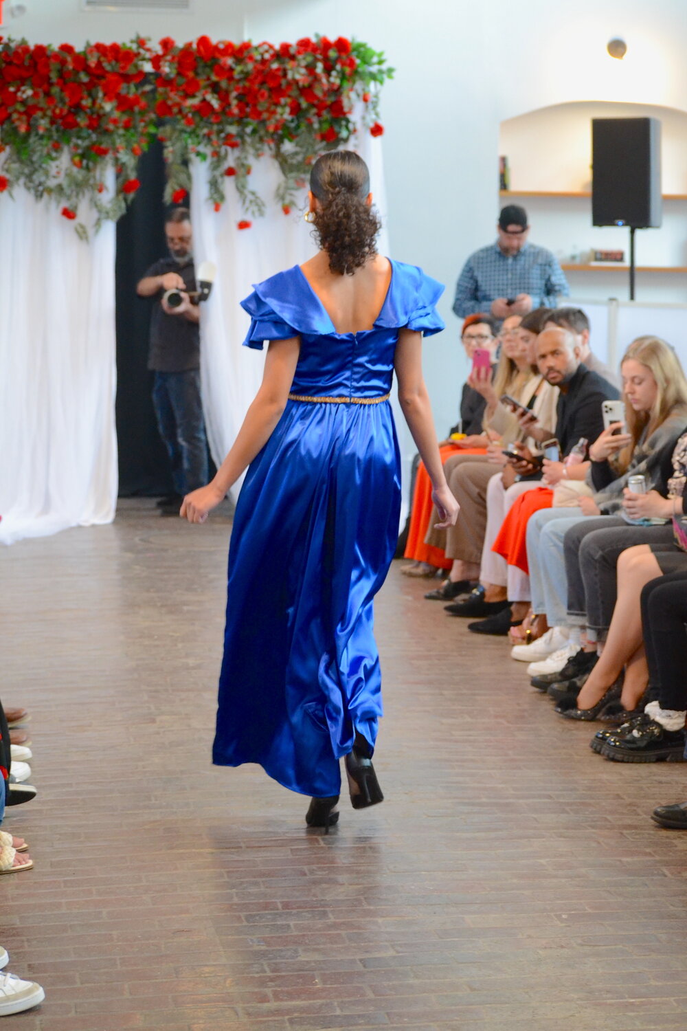 Aden Waddell, a Bristol resident, walks down the runway in a blue romper designed by Nicole Contente