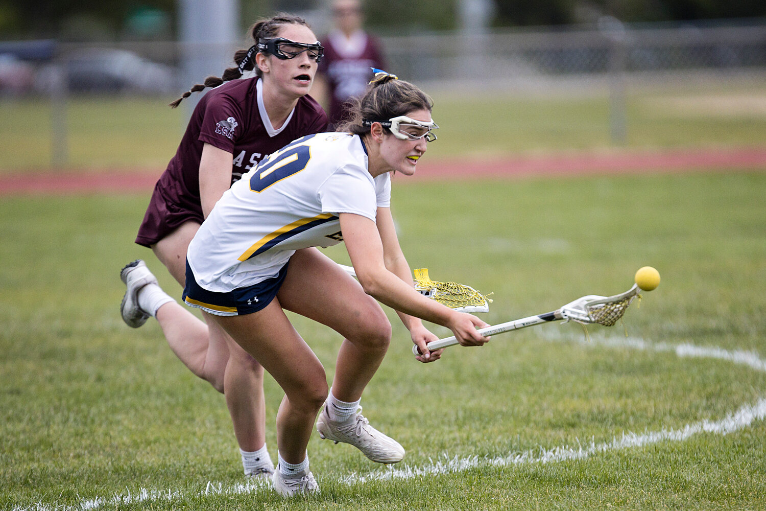 Barrington High School's Anna Lombardi scoops up a loose ball.