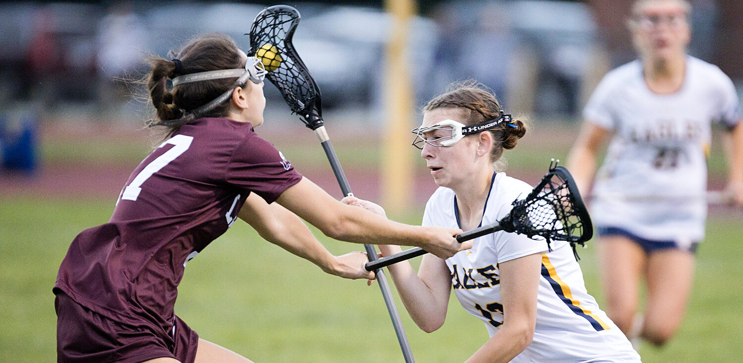 Barrington's Hannah Jackson is pressured by a LaSalle defender while clearing the ball away from the goal.