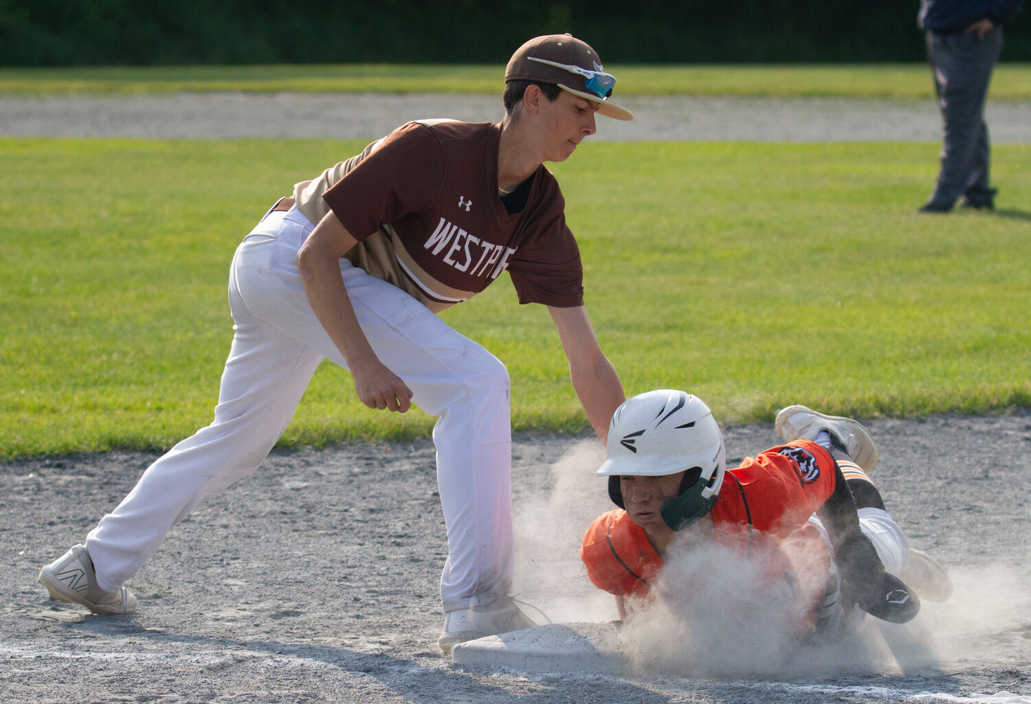 First baseman Luke Finglas tags a Diman runner during the Wildcats’ 8-0 home win over Diman on Tuesday.