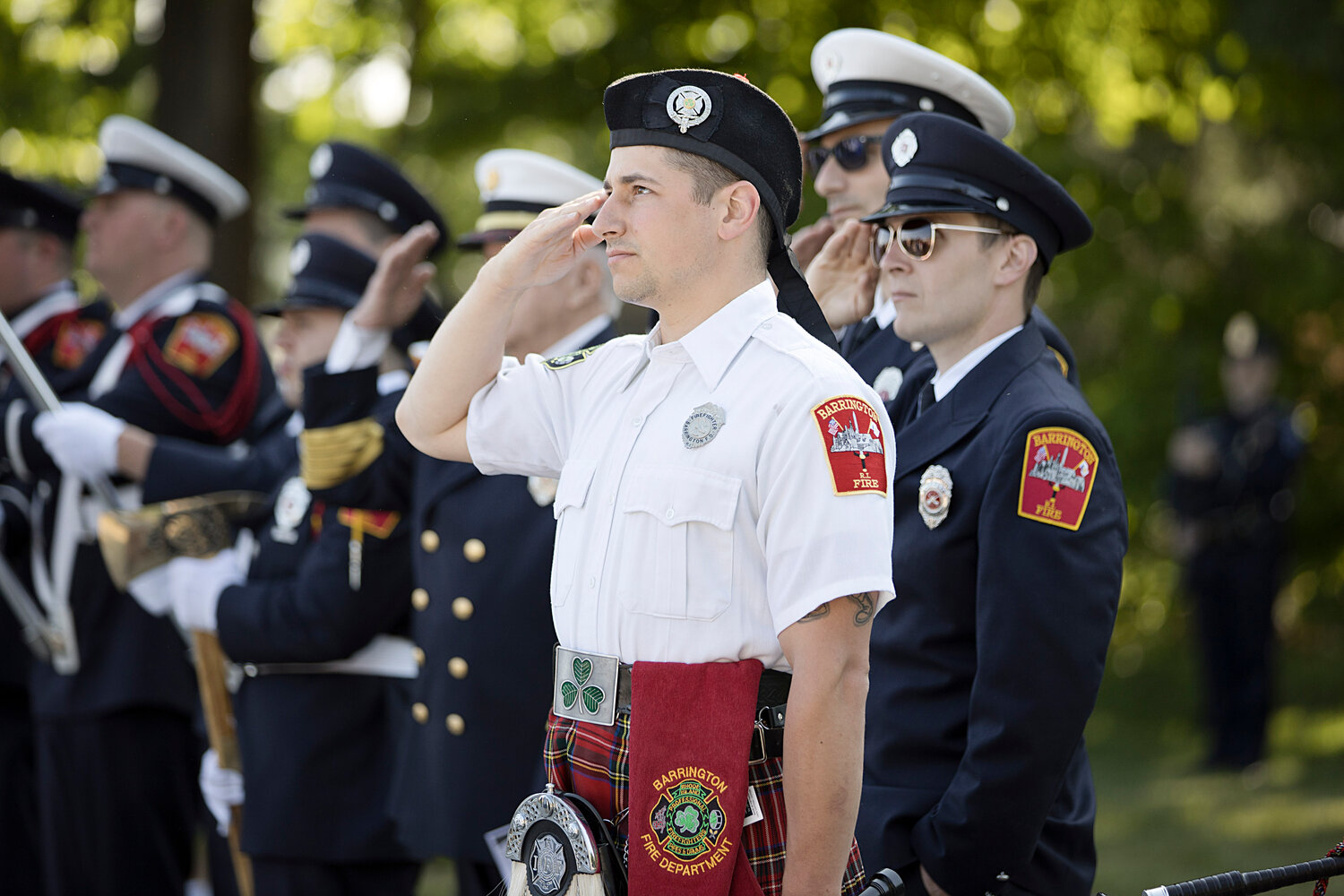 Members of the Barrington Fire Department salute the flag while TAPS is played.