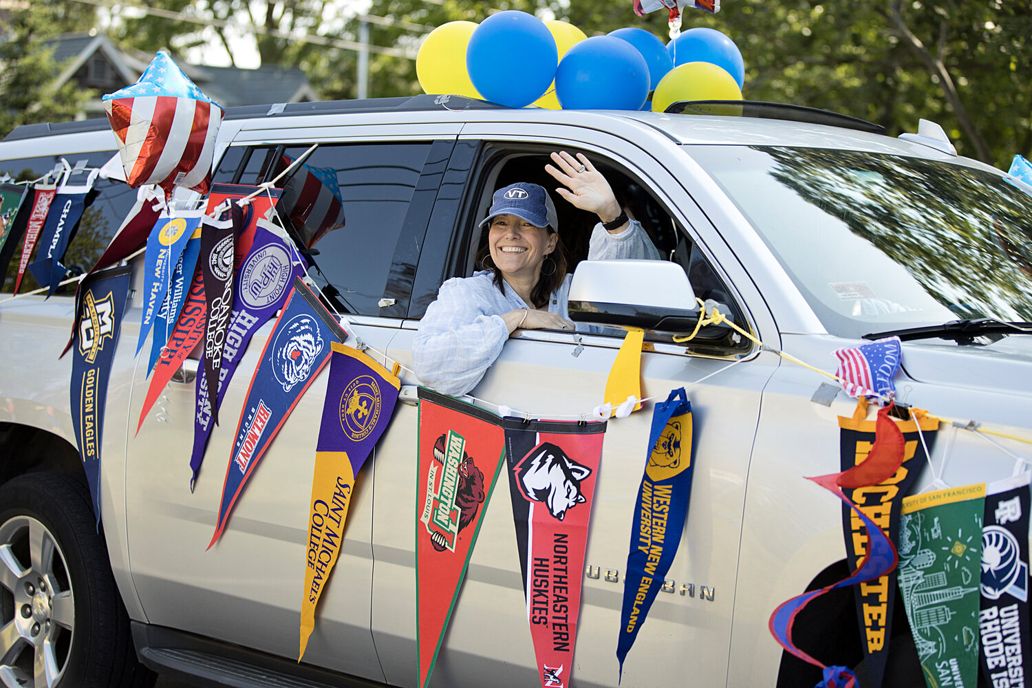 A member of the Barrington Education Foundation smiles and waves as she rides along the parade route.