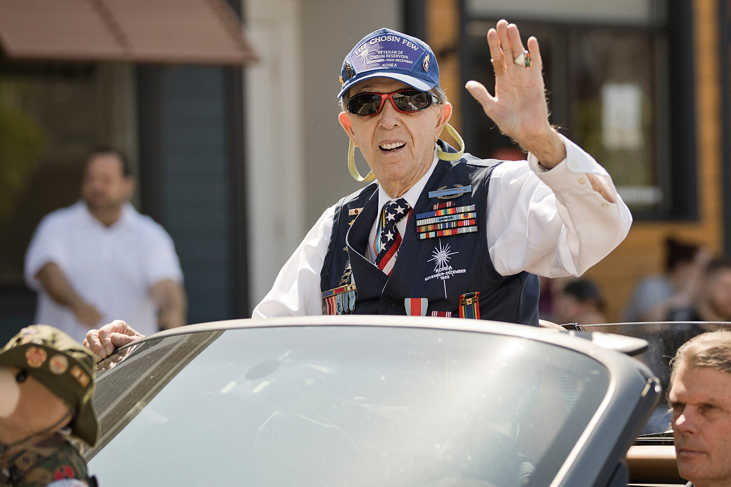 Thomas Dailey, Battle of the Chosin Reservoir, offers a wave while participating in the Memorial Day parade.