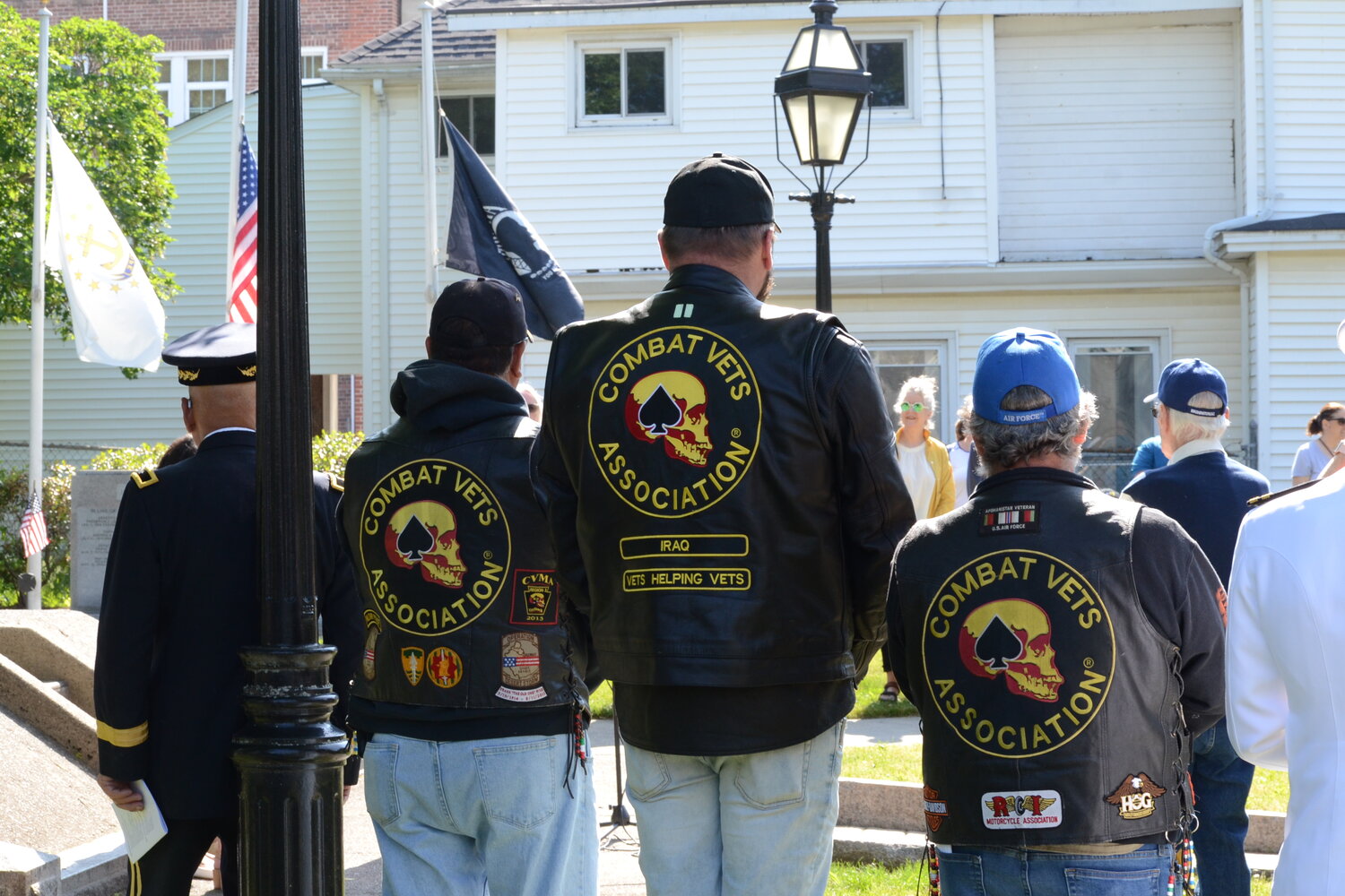 Francisco Chaves (military police), Derik Von Recum (U.S. Army), and Joe Delfino (U.S. Air Force) listen during the ceremony on the Town Common on Monday morning. All three are members of the Rhode Island chapter of the Combat Veterans Association.