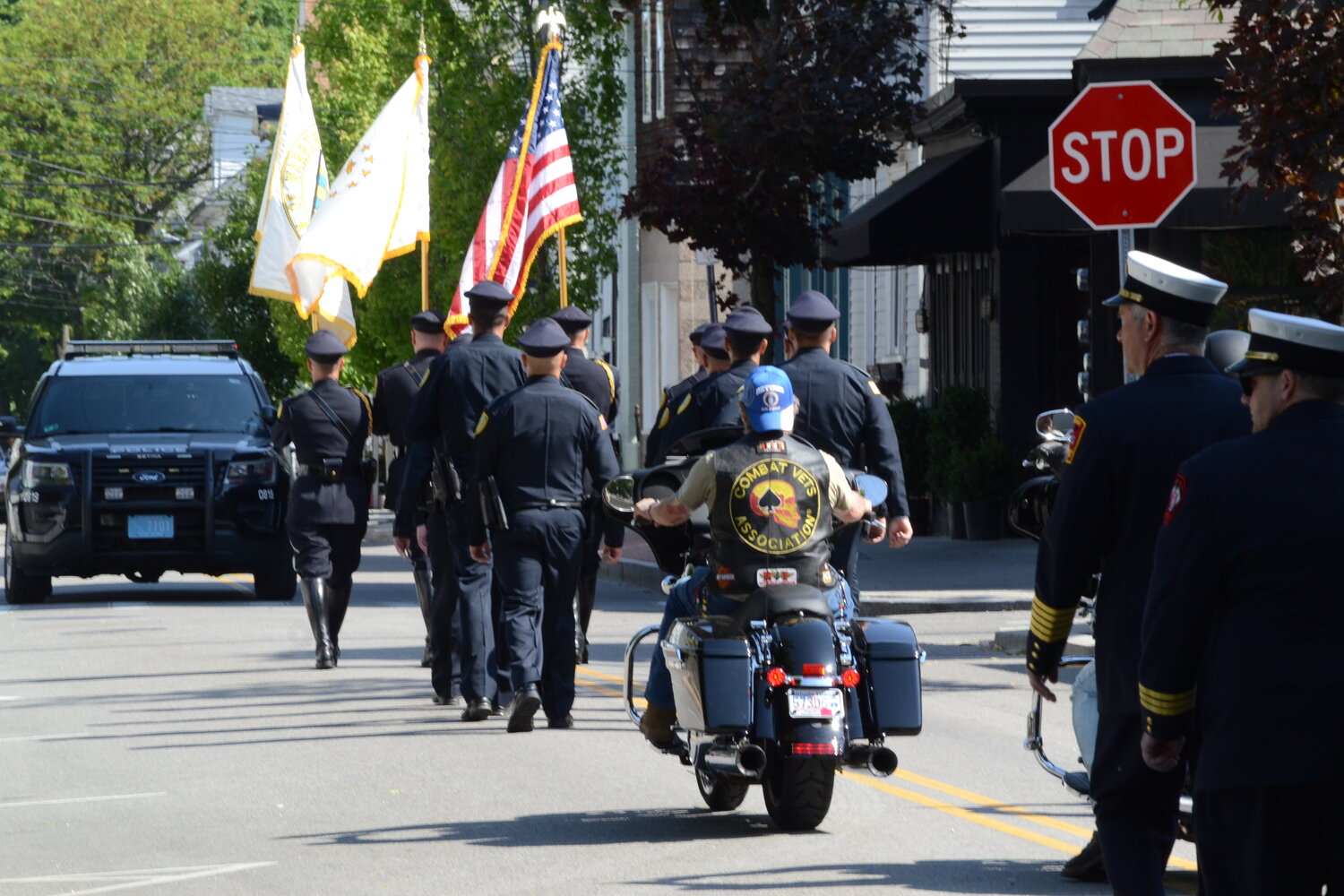 Police and fire personnel are joined by military combat veterans, military vehicles, various apparatus and local government representatives during the parade from the Town Common to the South Burial Ground on Memorial Day, May 29, 2023.