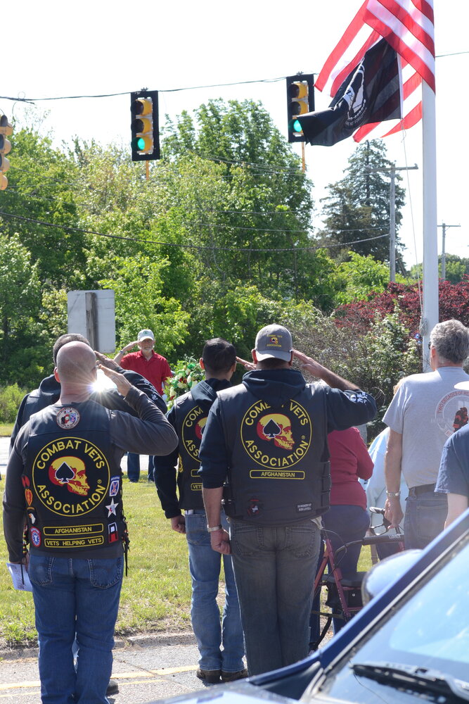 Veterans from the Combat Veterans Association salute the flag during the National Anthem on Sunday during a remembrance ceremony at Warren's Vietnam Memorial