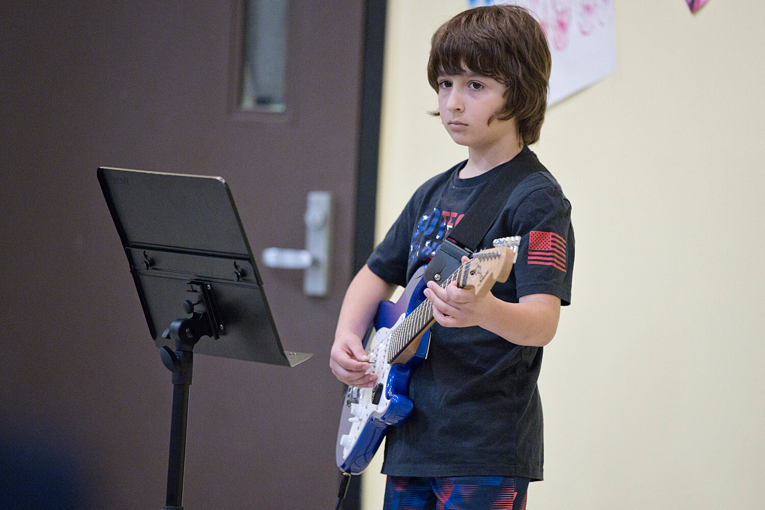 Hugh Cole student, Nicholas Mello, plays the National Anthem on electric guitar during Hugh Cole's Memorial Day assembly.