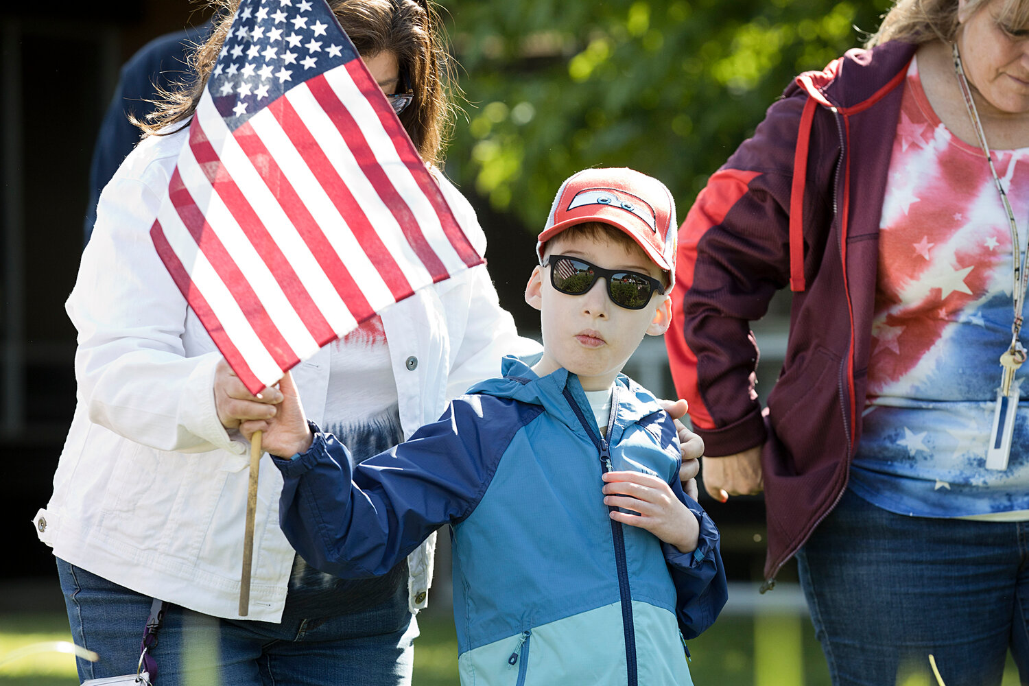 Gabriel White holds up a flag while participating in Hugh Cole's Memorial Day observation, Friday.