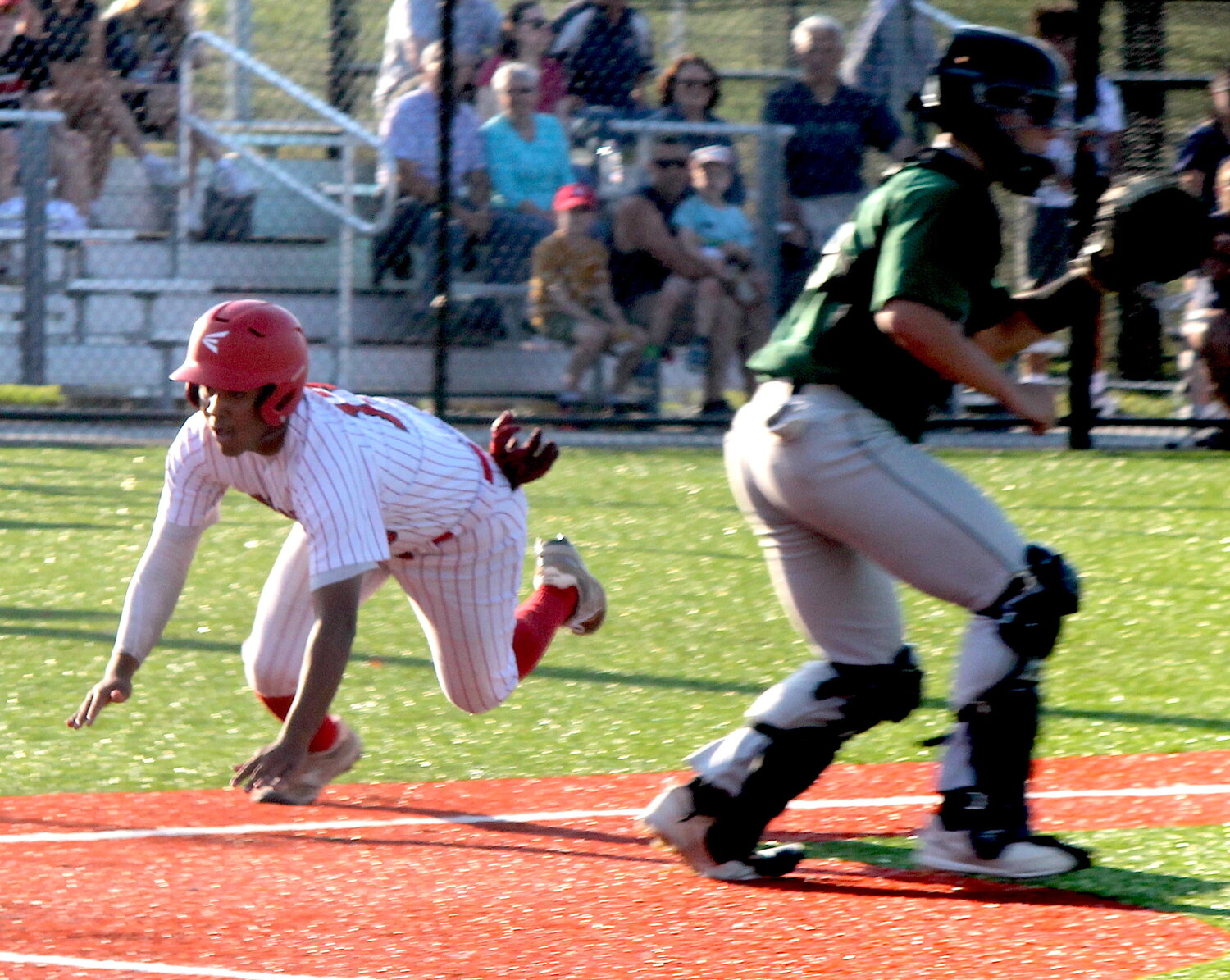 Zuriel Vargas slides safely into home with the third EPHS run of the first inning of the Townies' eventual 9-1 win over Ponaganset.