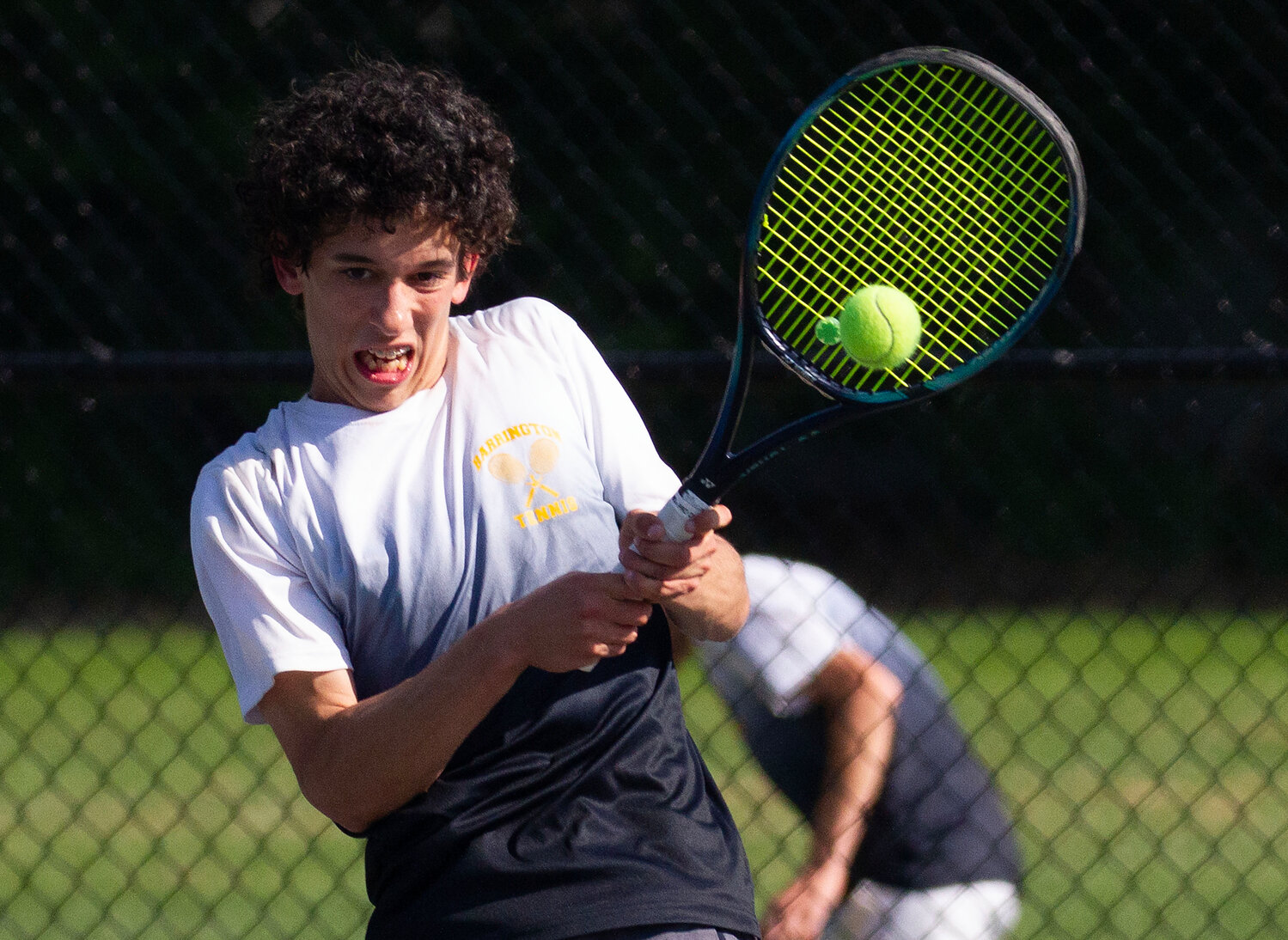 Luke Sapolsky returns a shot during his match at number one singles.