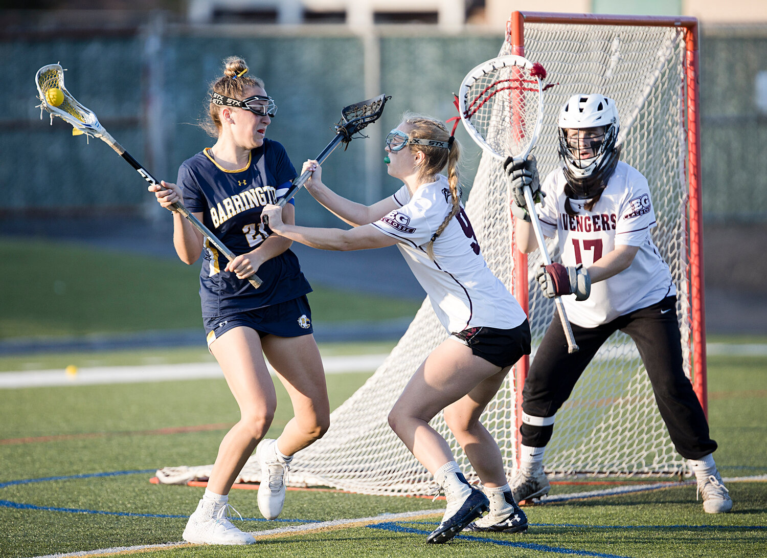 An East Greenwich defender attempts to push Violet Gagliano away from the goal.