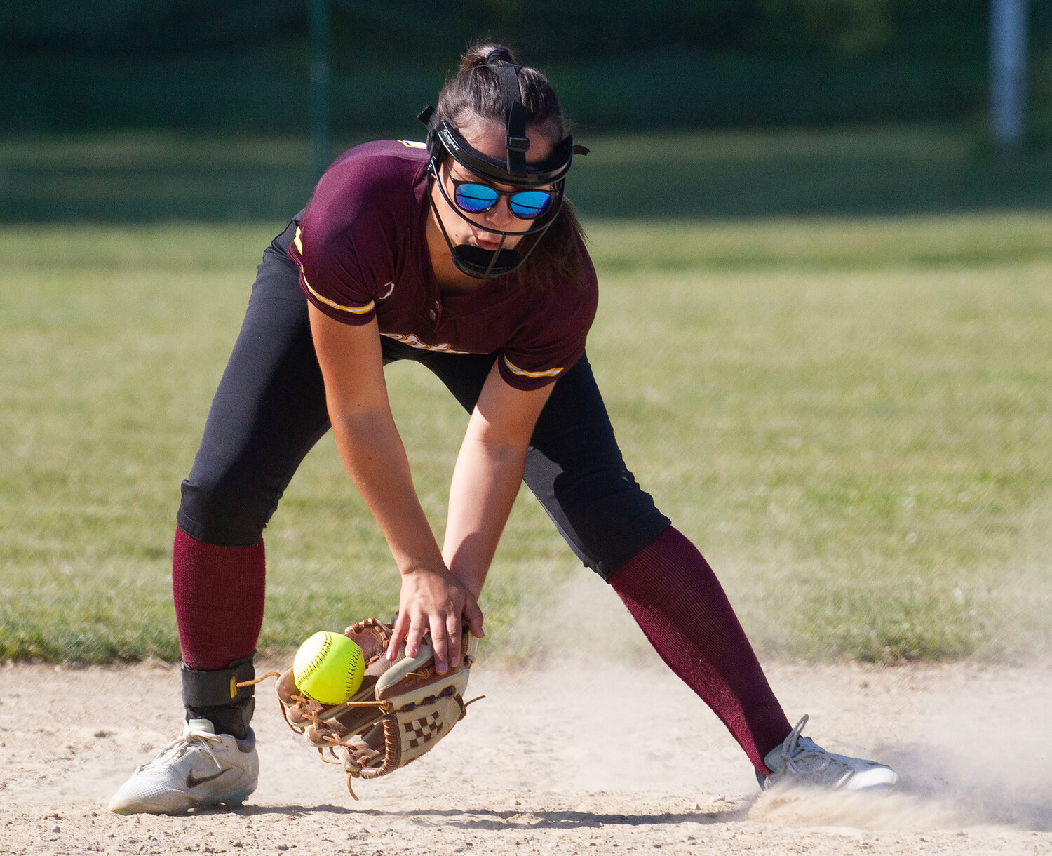 Mackenzie Oliveira scoops up a grounder during the game.