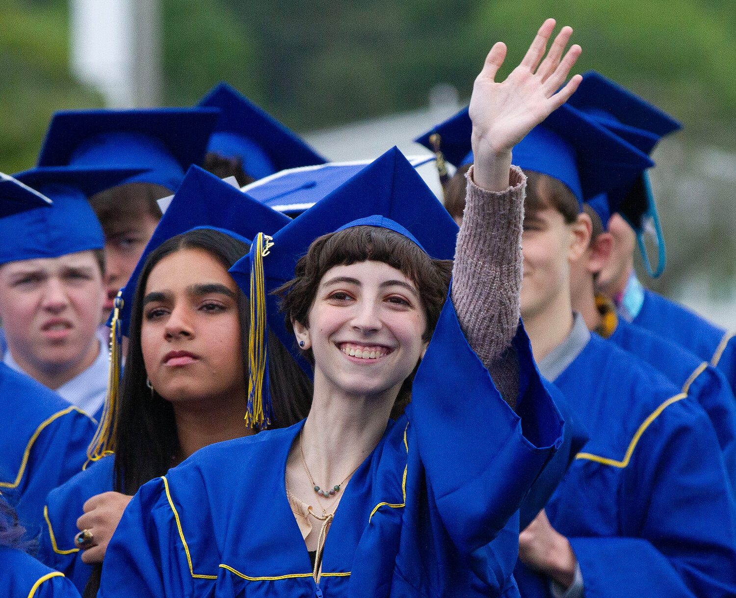 Grace Delaney waves to the crowd during Sunday’s graduation ceremony.