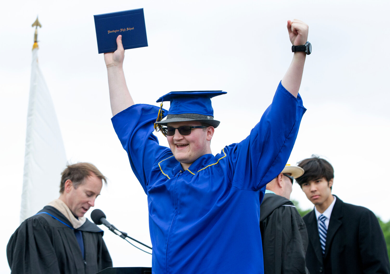 Austin Hall raises his hands in the air after receiving his diploma.