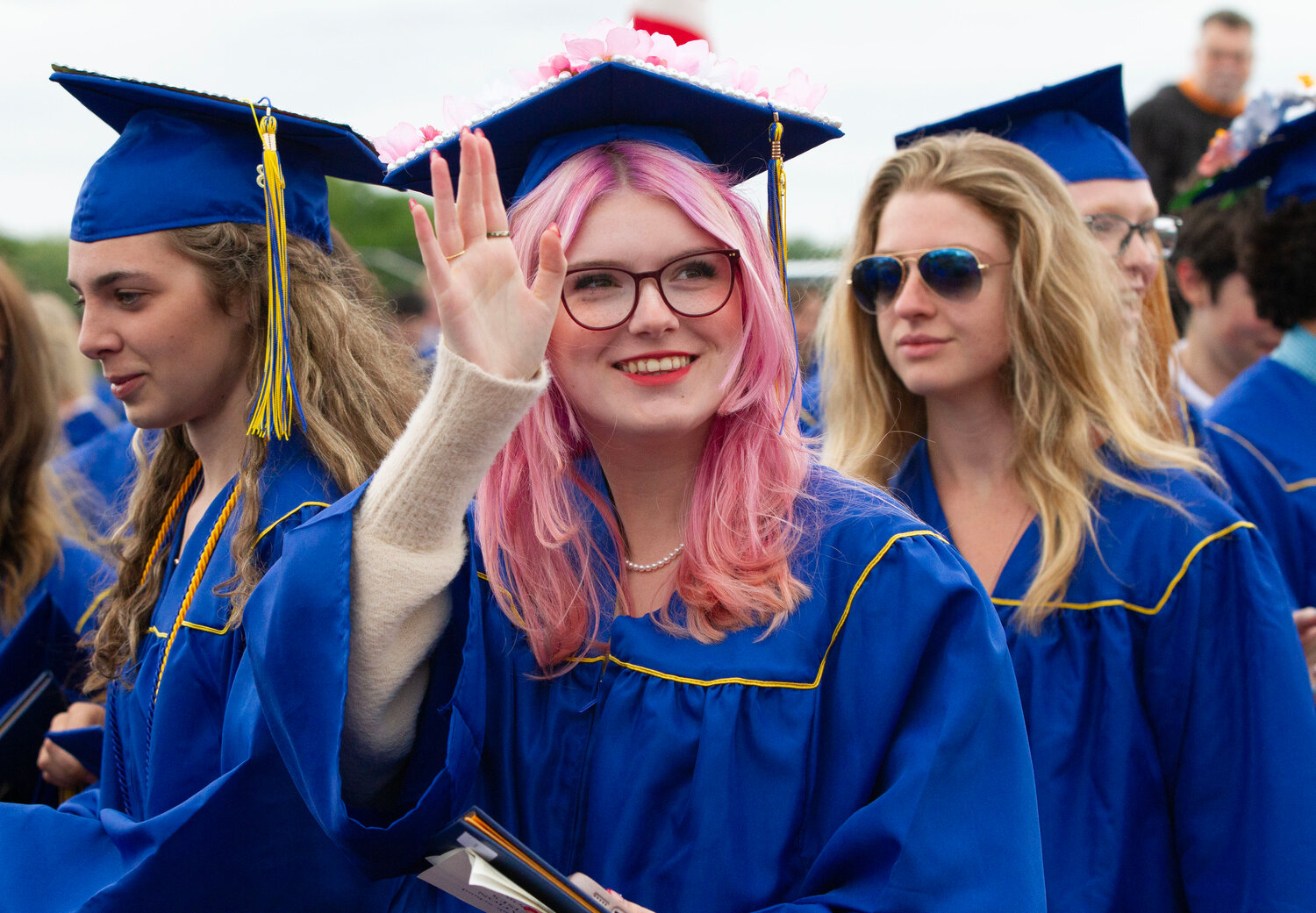 Willow Rathbone waves to the crowd during Sunday’s graduation ceremony.