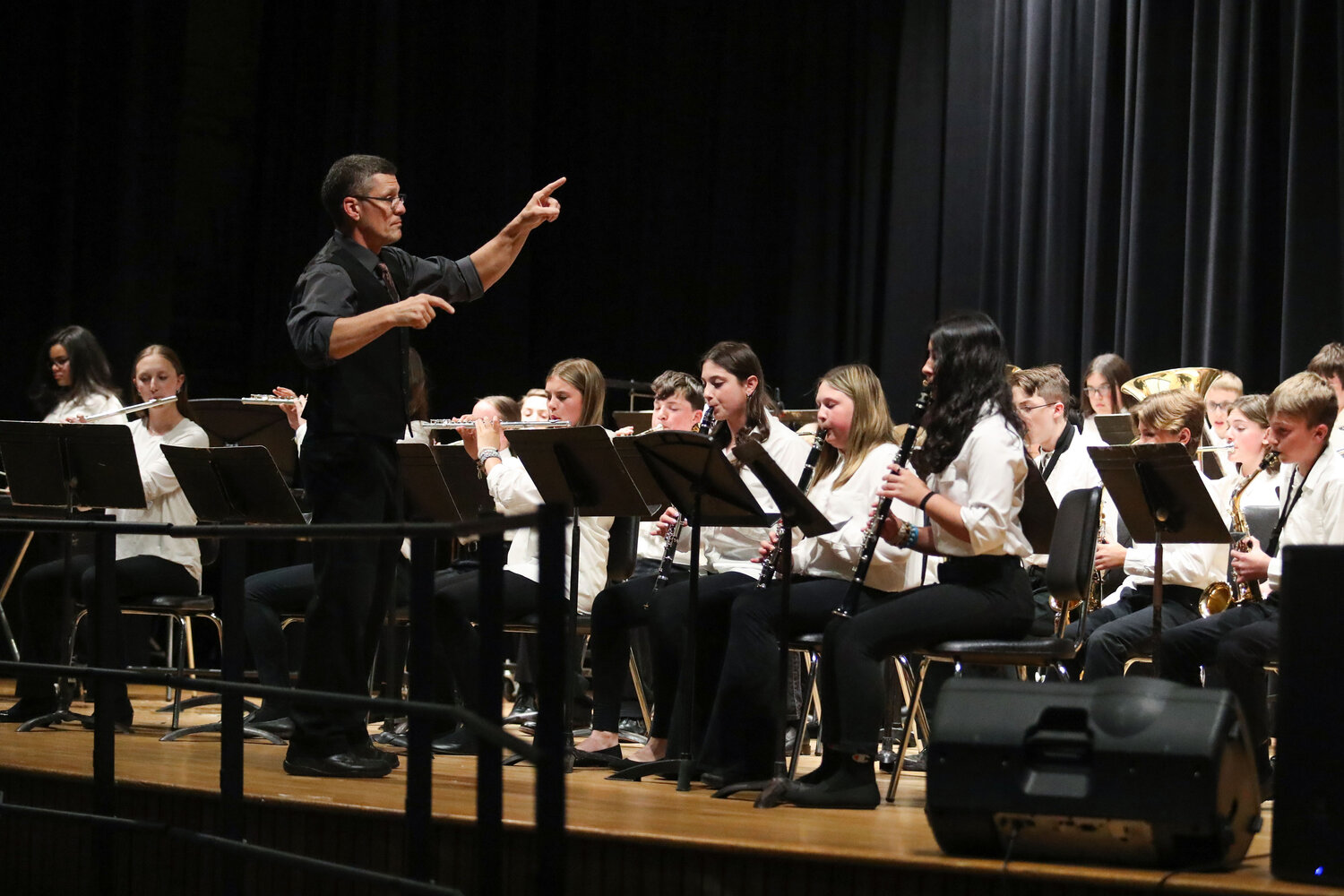 Michael Alves directs the concert band during Tiverton Middle School’s spring concert at the high school