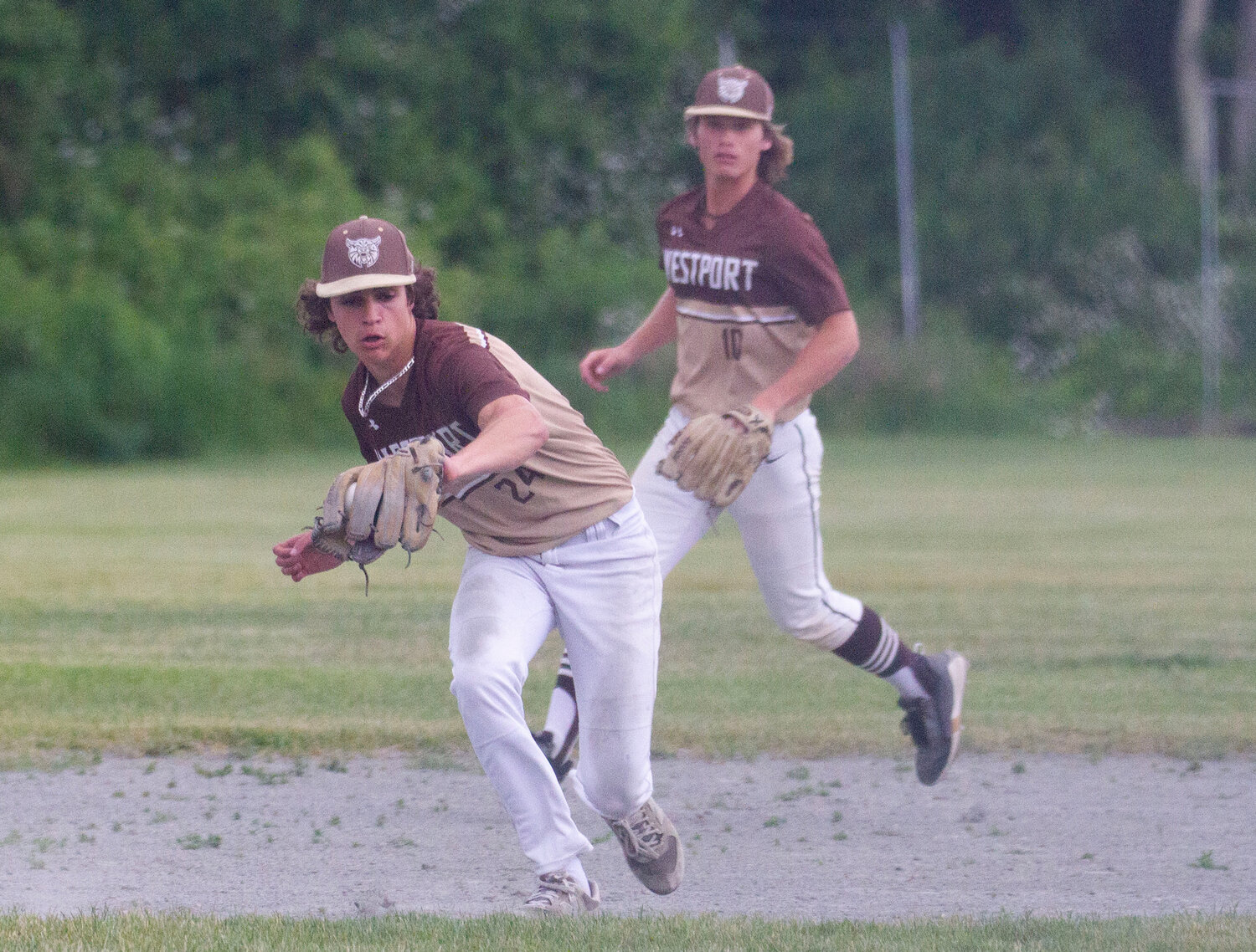 Third baseman Vaughn Costa scoops up a grounder with shortstop Noah Sowle looking on.