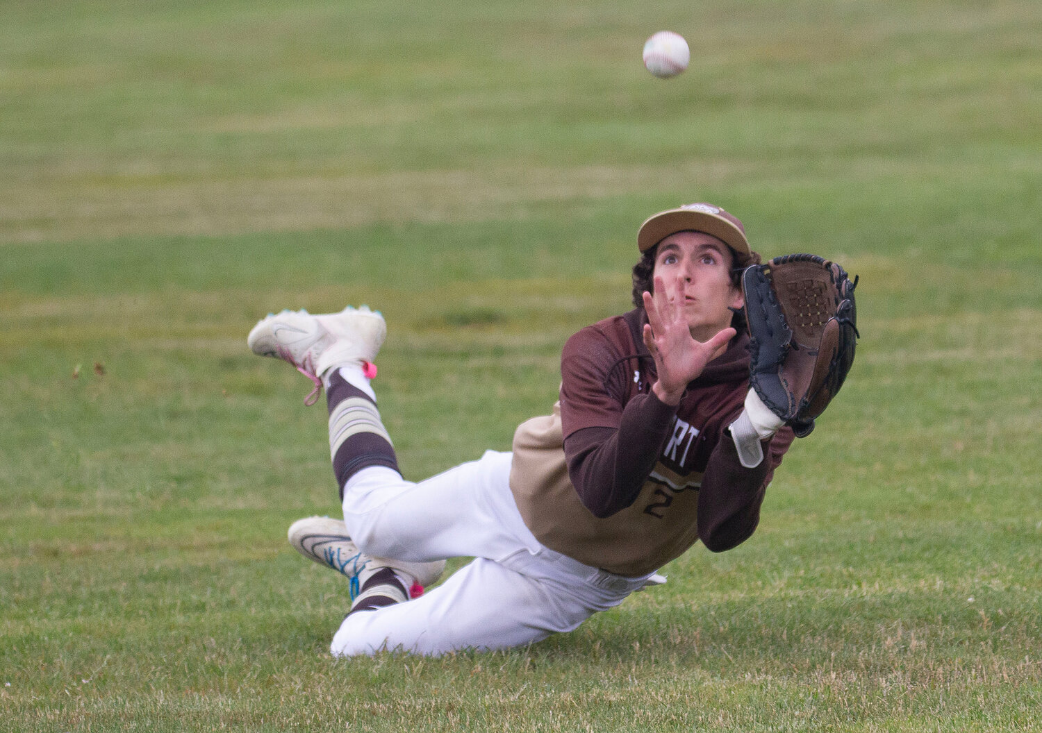 Ben Boudria dives to catch a flyball in right field. But the ball pops free when he crashes to the ground. Boudria played excellent defense making three catches in right field. he also scored the Wildcats game tying run in the seventh inning to even the score at 2-2.