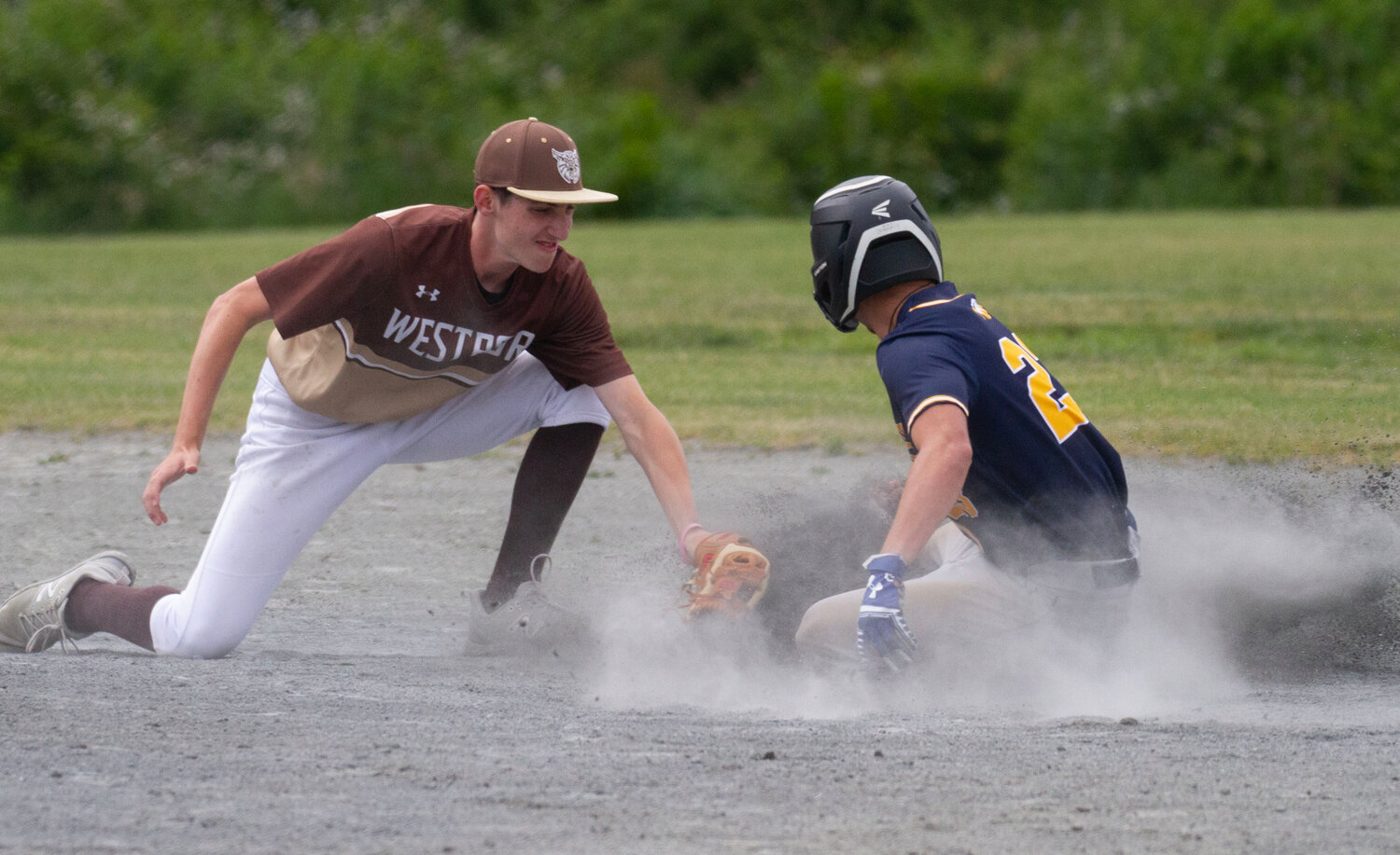 Second baseman Will Souza attempts to tag out a Mount Everett base runner stealing second base.