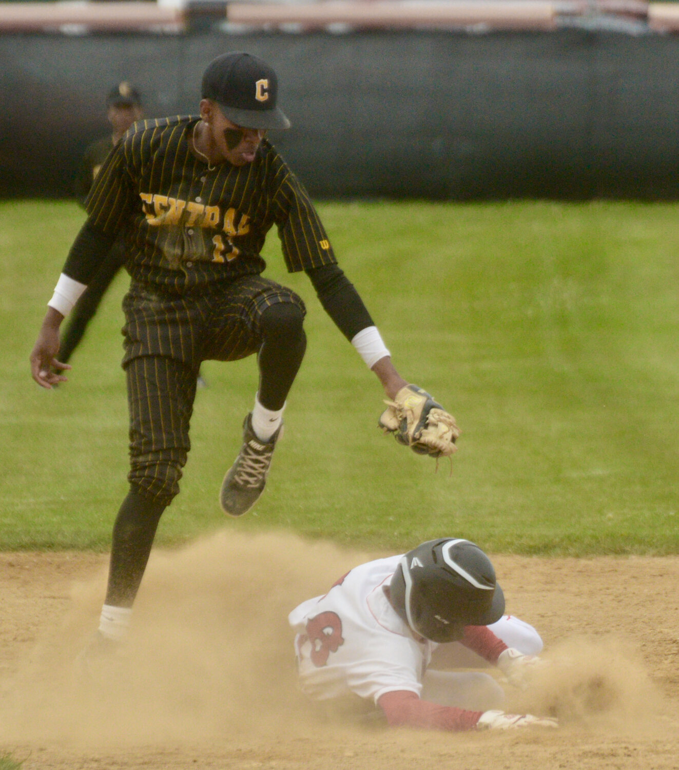 Patriots sophomore Charles Cord slides safely into second under a Central player’s tag late in Monday’s game.