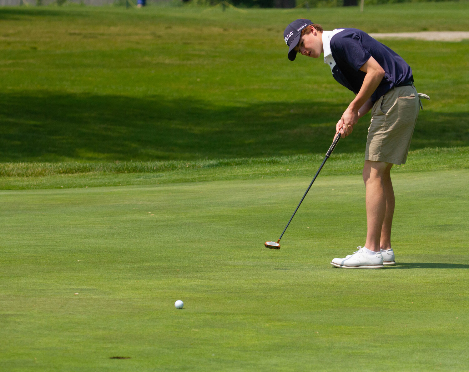 Barrington High School’s Adam Gorman hits a putt at the state golf tournament. Gorman finished with a two-day total of 153.