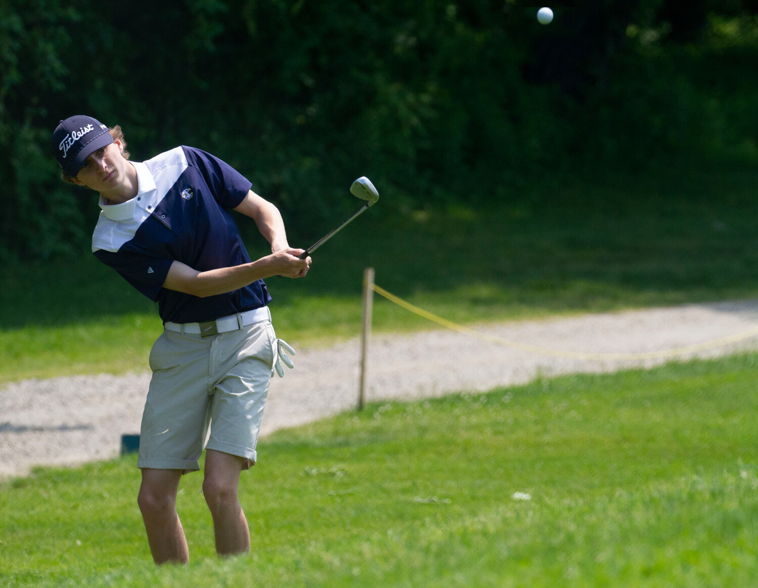 Barrington High School’s Sean Bonneau chips a shot toward the green during the first day of the state tournament.