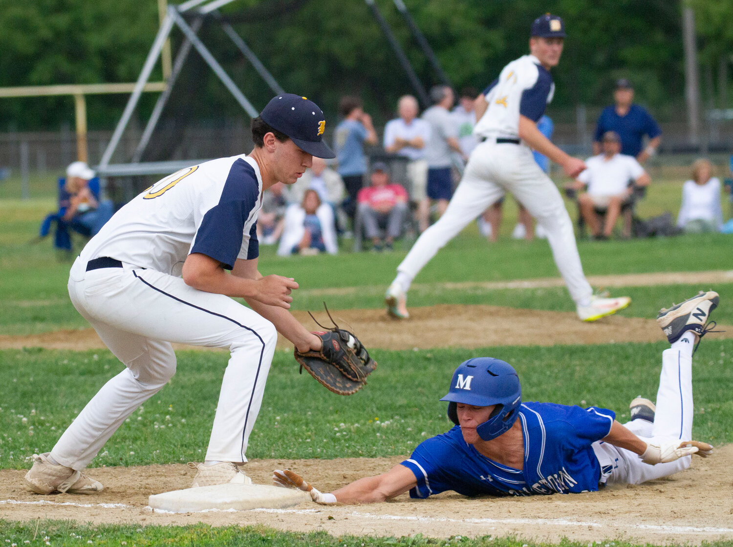 Nick Scandura takes a pick-off throw from pitcher Harrison Cooley during Friday’s game.