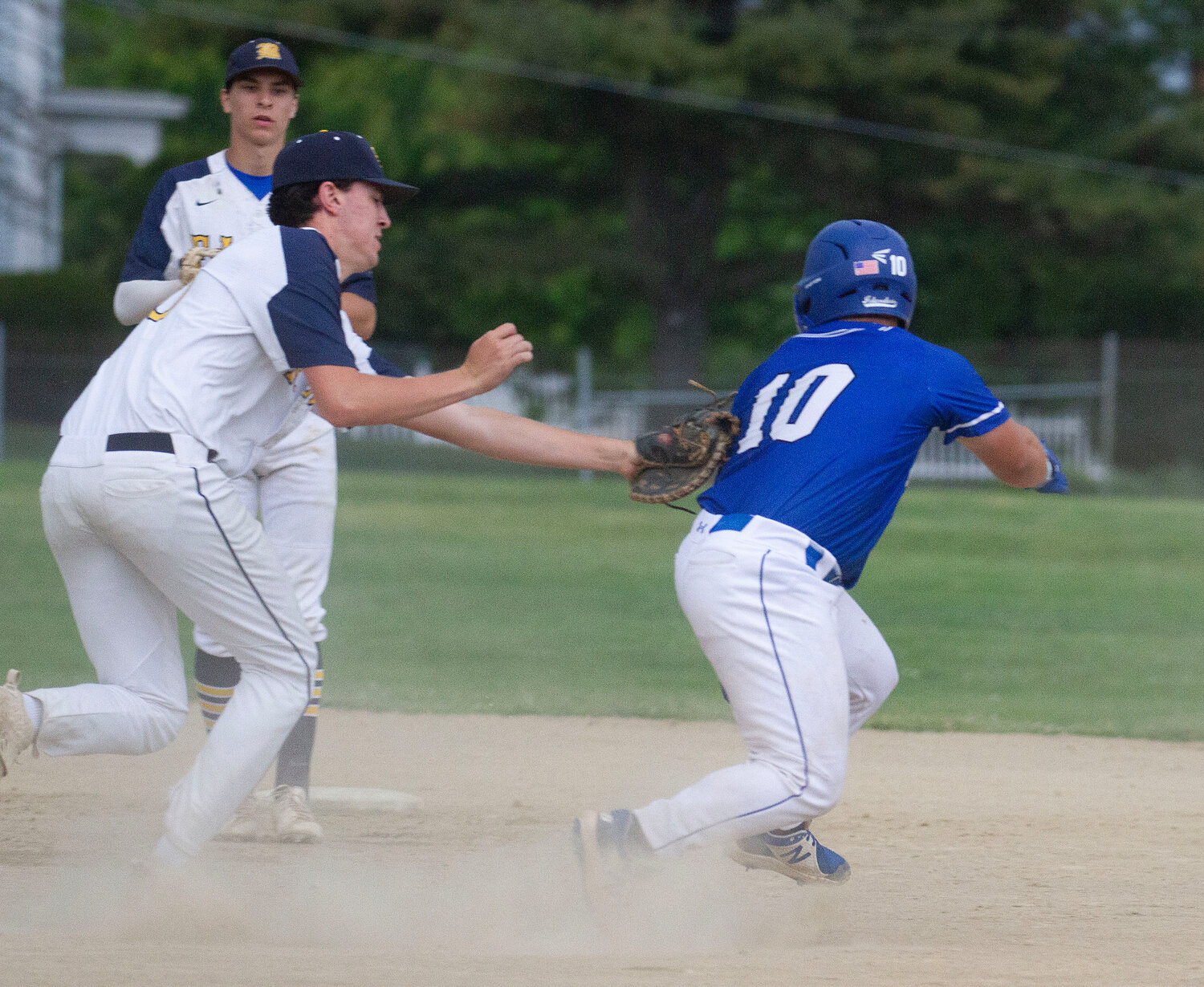 Nick Scandura tags a Middletown baserunner who was caught in a rundown during Friday’s game.